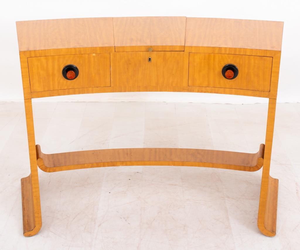 Art Deco style semicircular vanity table, with three hinged compartments and drawers above a plinth base. 

Dealer: S138XX