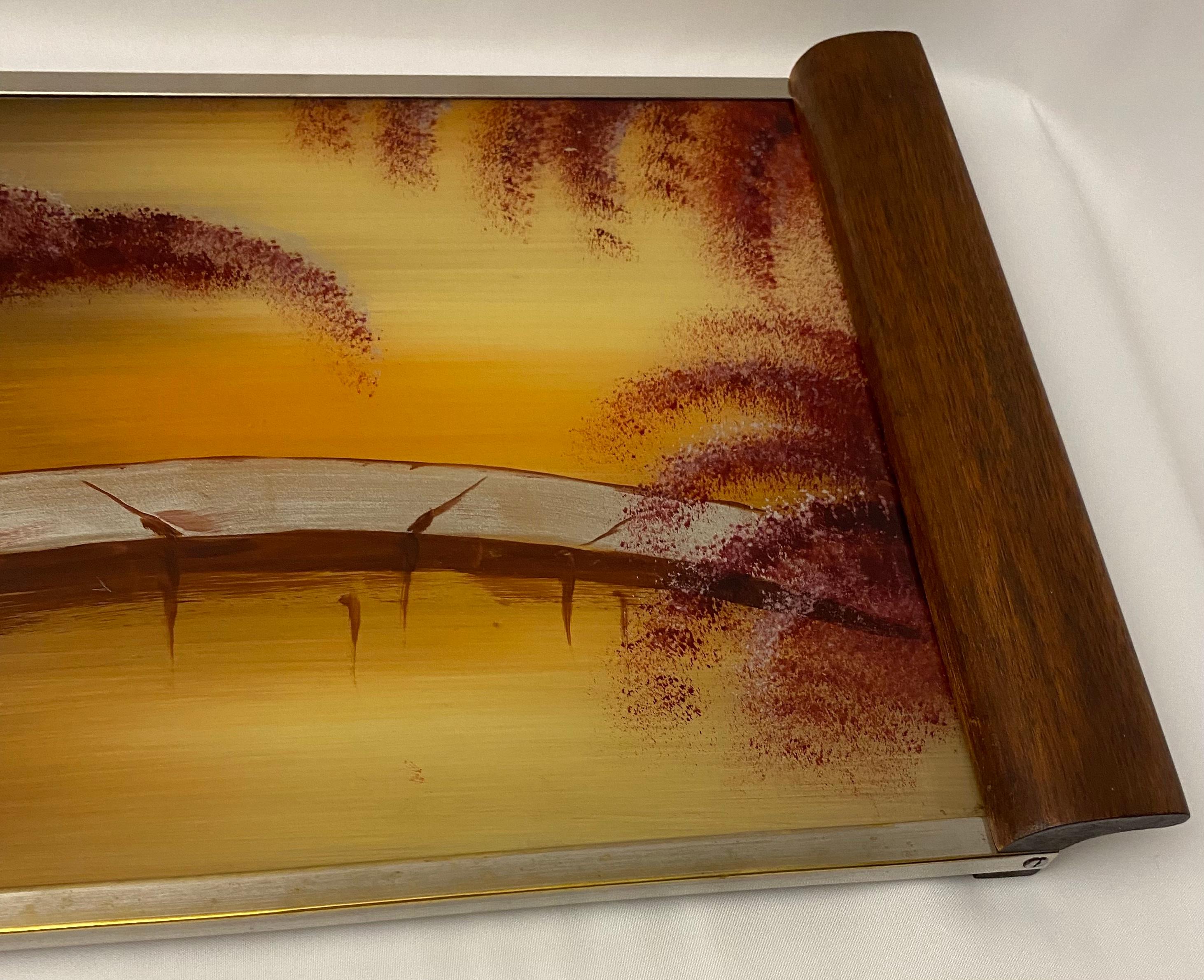 This elegant serving tray features Japanese cherry blossom scenes painted on glass and art deco period designs. This is a beautiful example perfect for collectors of Art Deco objects or for someone simply looking for a lovely tray to present drinks