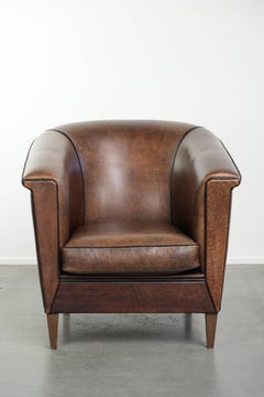 Art Deco style sheepskin club armchair finished with black piping
