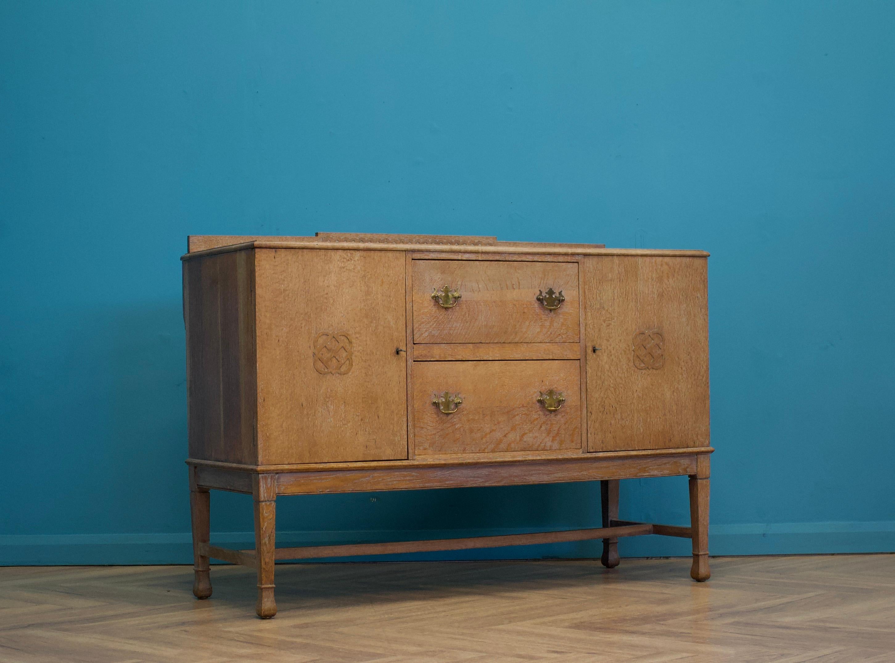 A quality limed oak Art Deco style sideboard, circa 1950's- in the manner of Heals


Featuring two drawers and two cupboards with shelves


