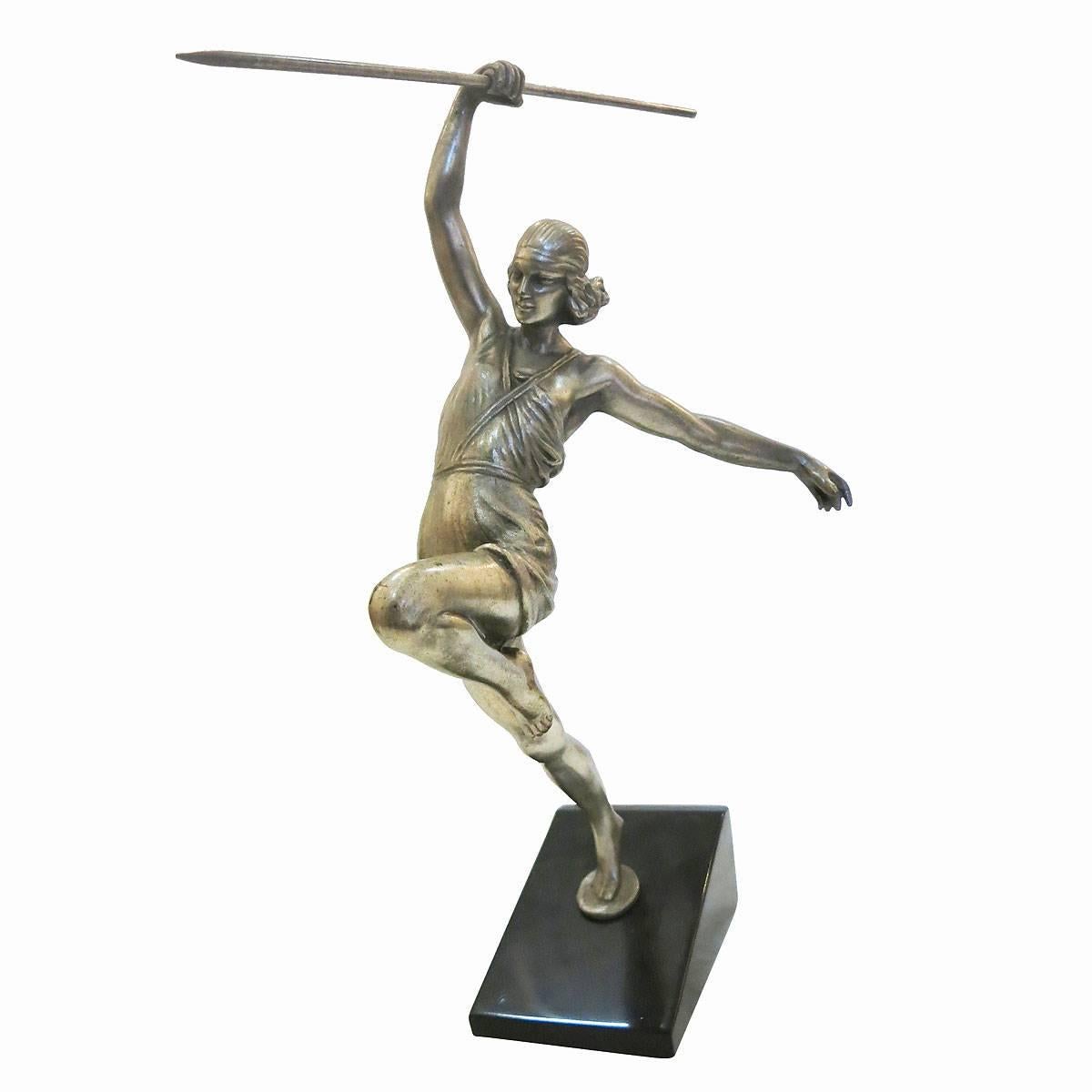 Art Deco style solid bronze casting with an antique silver finish of a female Roman warrior, in mid attack, throwing a spear. The piece is mounted on a mirror polished black marble base. This high quality piece was reproduced from the original