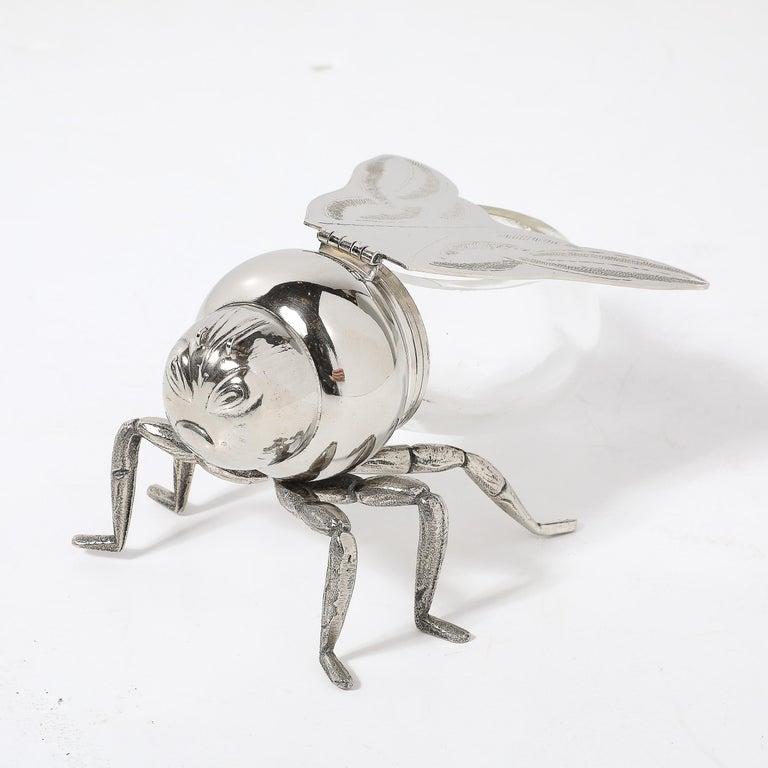 This Art Deco silver-plated and glass bee honeypot by Antares is a delightful example of elegant design from the 1960s. Crafted in Italy, this honeypot showcases the sophisticated and streamlined aesthetic characteristic of the Art Deco