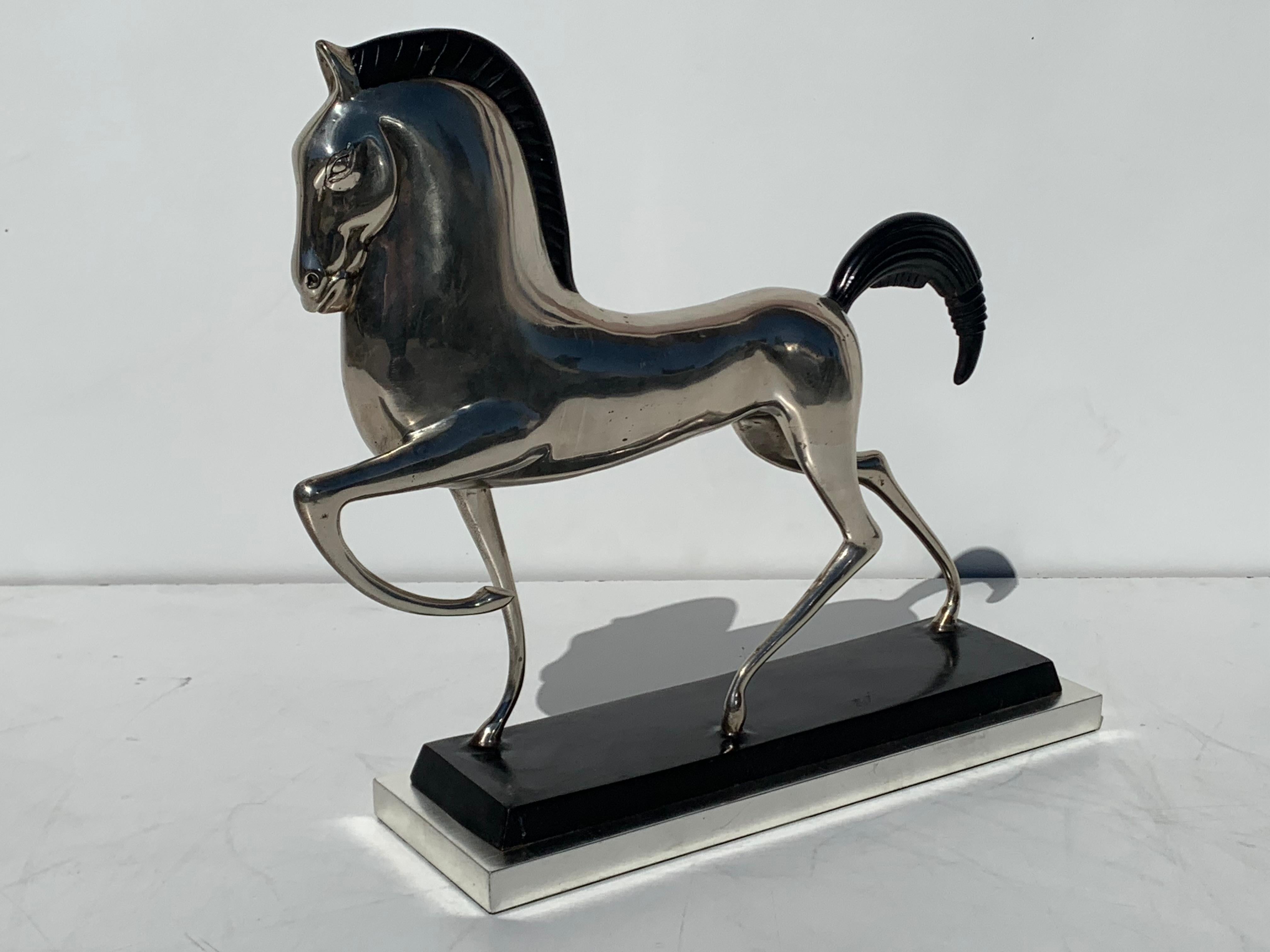 Art Deco style silvered brass Etruscan horse sculpture on 12-karat white gold leaf base.

 