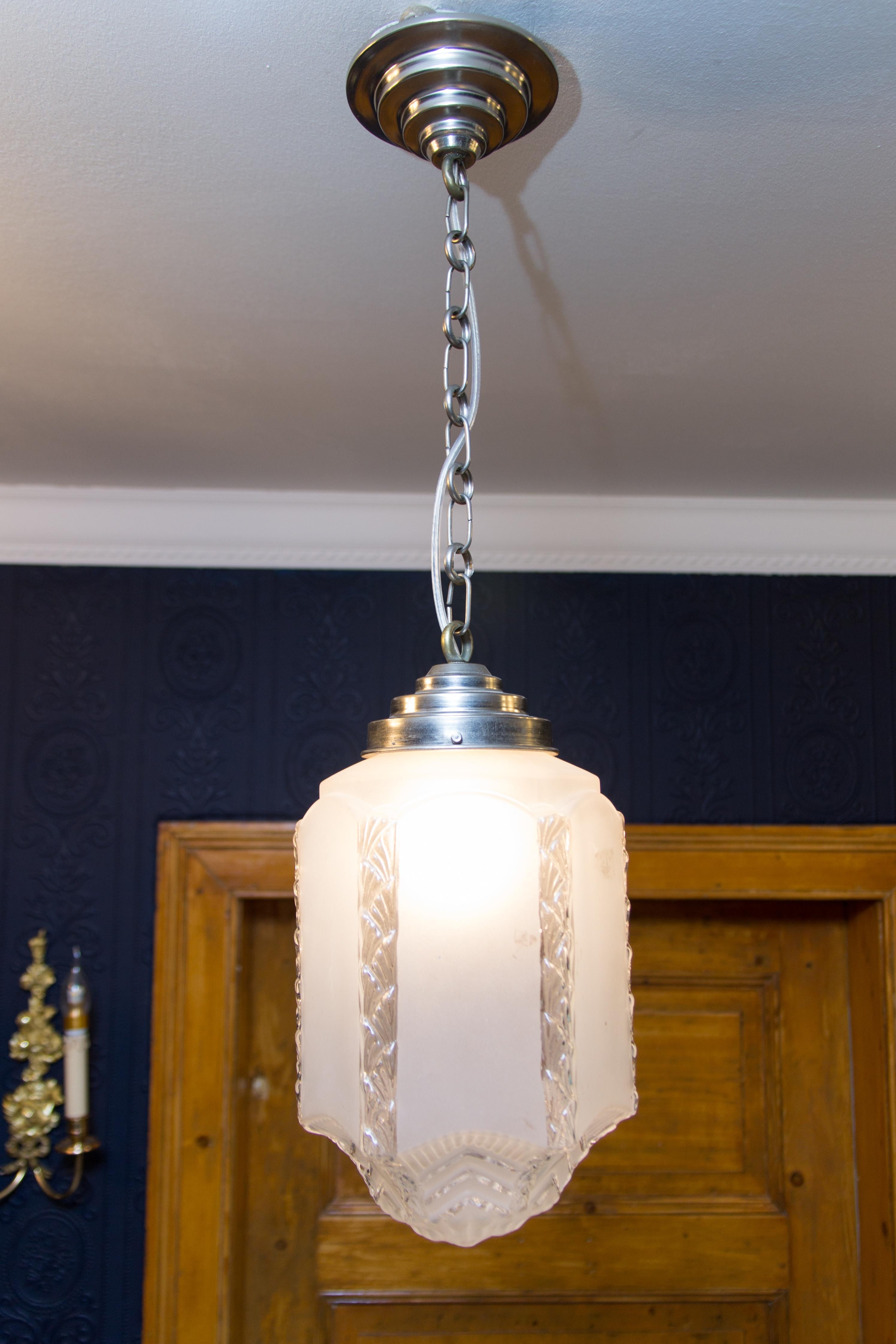 Art Deco style pendant light with frosted glass skyscraper shade from the 1930s.
Measures: Total height is 26.3 inches / 67 cm; height without chain - 11.8 inches / 30 cm; diameter - 7.9 inches / 20 cm.