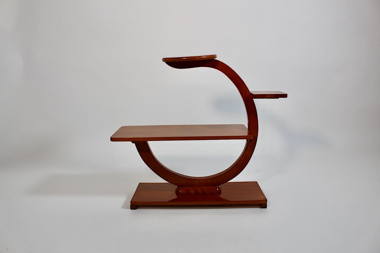 Art Deco Style solid cherrywood flower stand or flower shelf with three ( 3 ) cups 1970s Austria.
An amazing Art Deco style flower stand or flower shelf from solid cherrywood with three ( 3 ) cups in different shape shellac polished by hand.
This