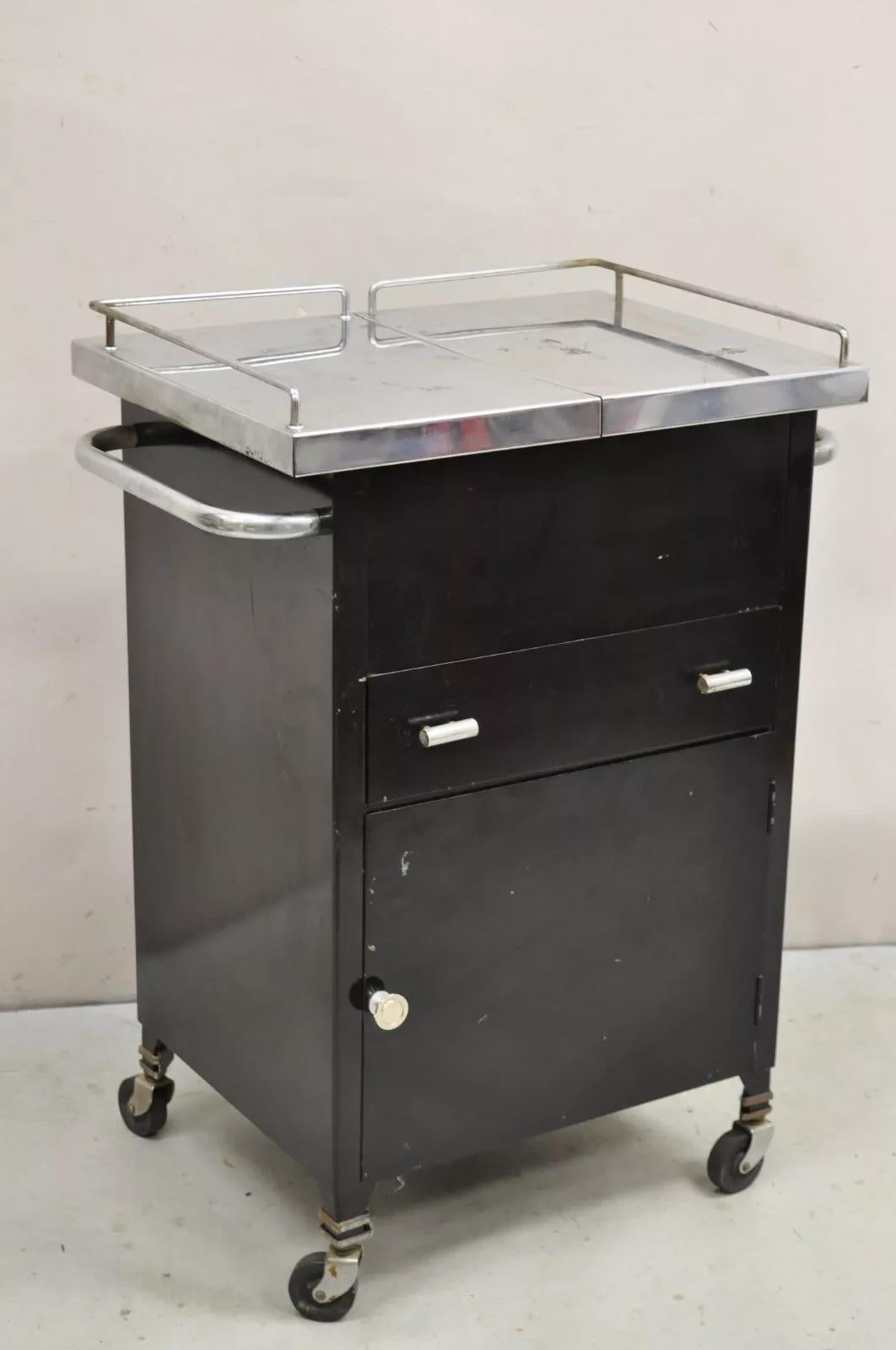 Art Deco Style Stainless Steel Metal Black Rolling Medical Dental Cabinet Table. Circa Mid 20th Century. Measurements: 34.5