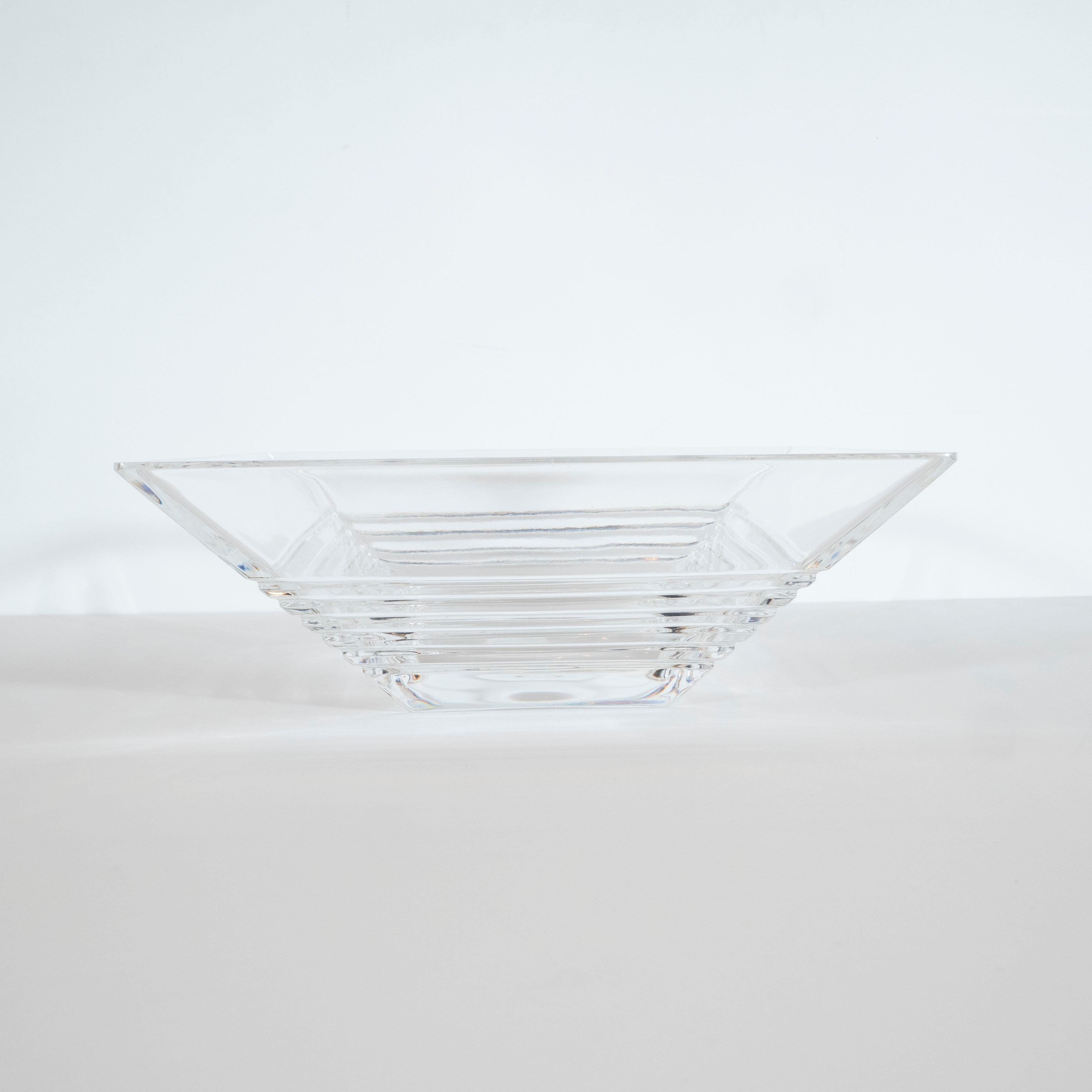This elegant Art Deco style crystal decorative bowl was realized by Tiffany & Co. One of America's premiere luxury makers of the finest silver and precious objects since 1837, circa 1980. Inspired by skyscraper style Art Deco designs, the bowl