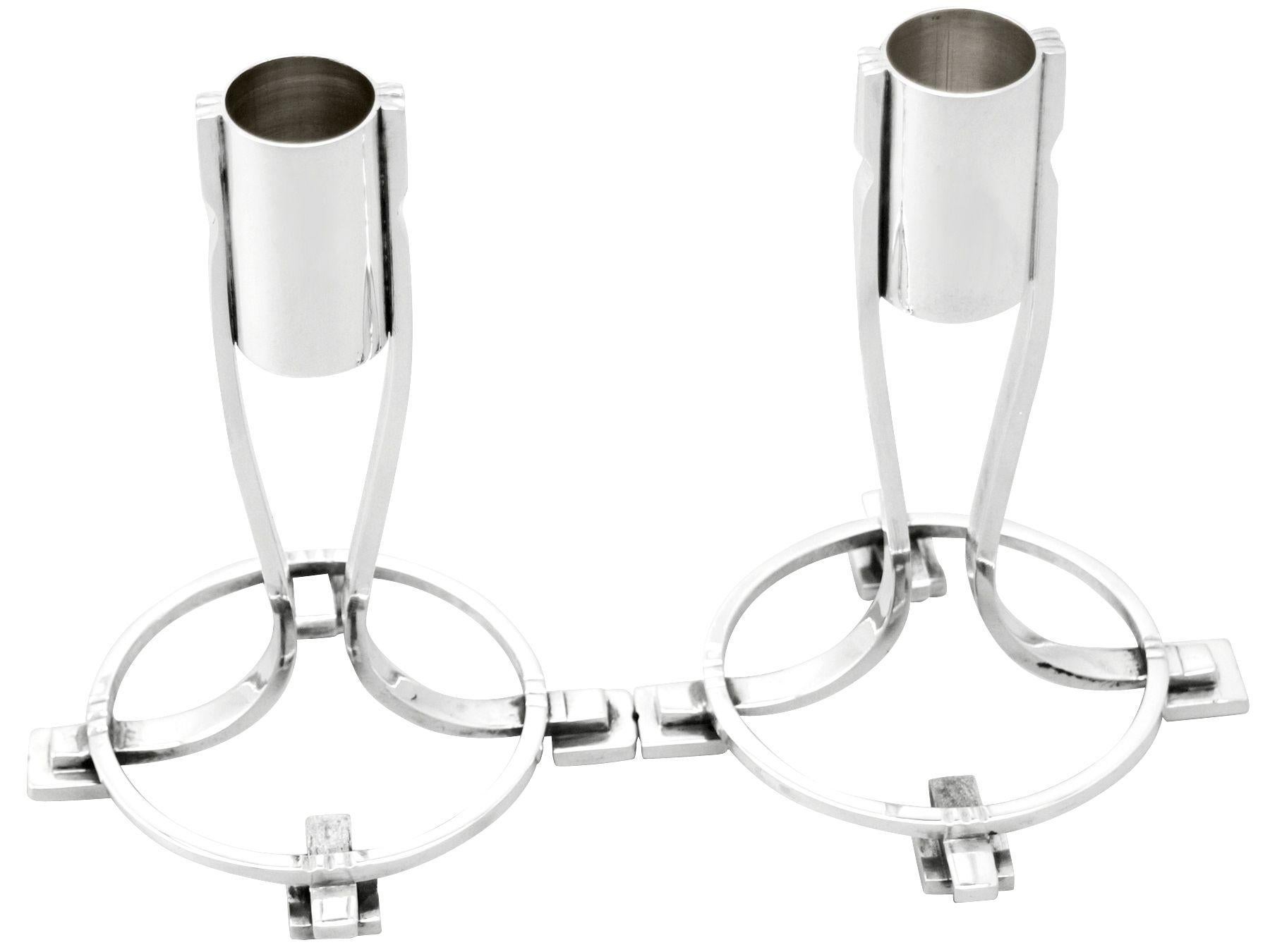 A fine and impressive pair of vintage Elizabeth II English sterling silver candleholders in the Art Deco style; an addition to our ornamental silverware collection.

These vintage Elizabeth II sterling silver candleholders have a circular waisted