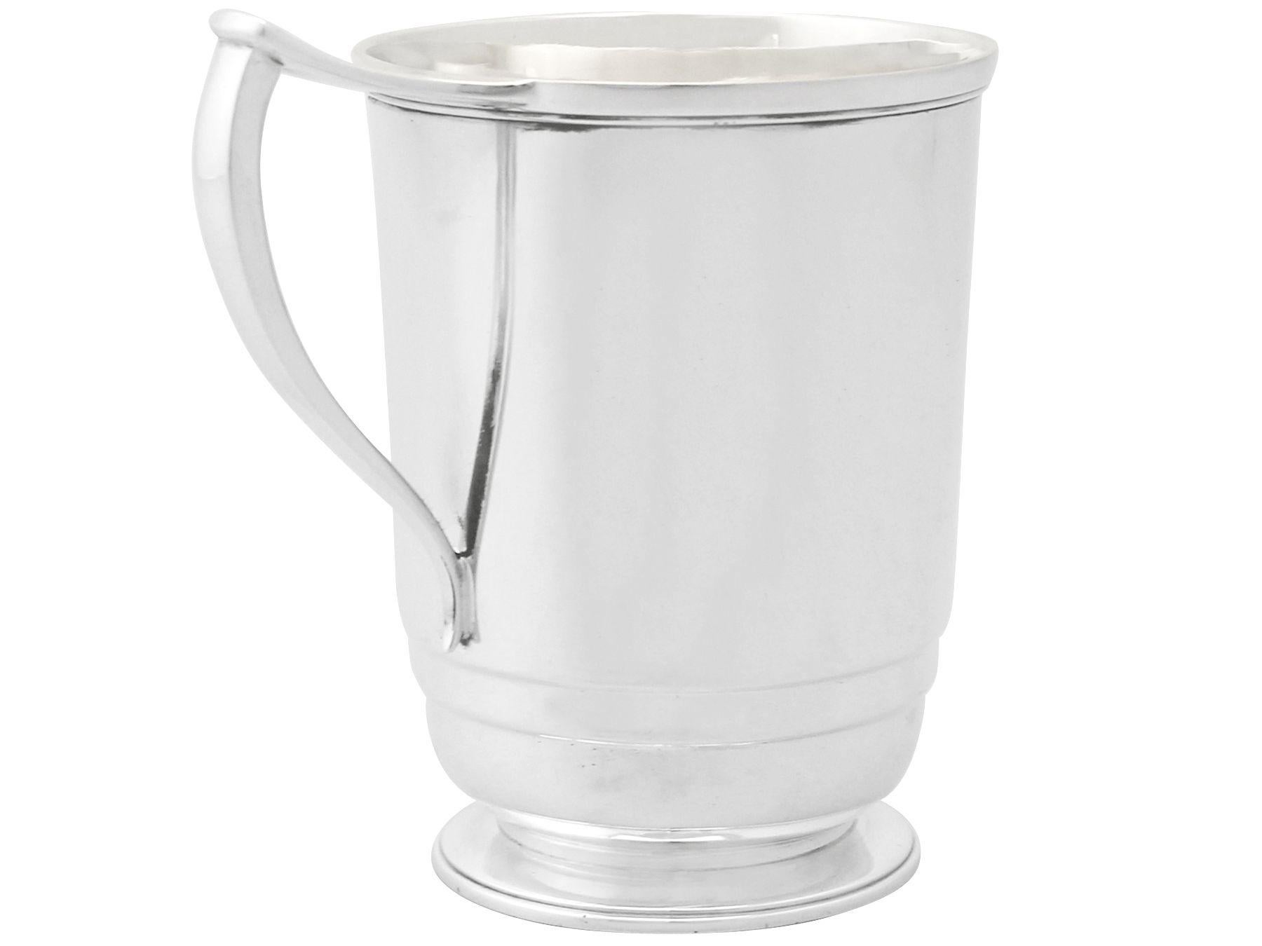 An exceptional, fine and impressive vintage Elizabeth II English sterling silver character christening mug in the Art Deco style; an addition to our silver christening gifts collection.

This exceptional vintage Elizabeth II sterling silver