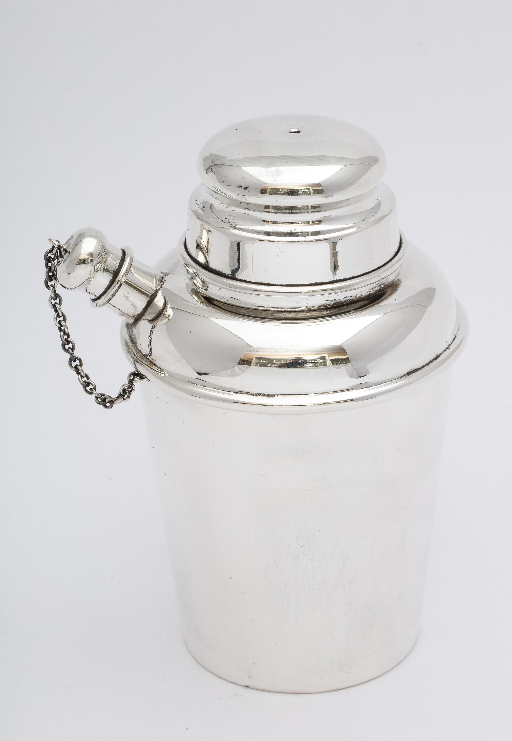 Art Deco Style, sterling silver cocktail shaker, Reed and Barton, Taunton, Mass., year-date marked for 1951. Measures 5 1/8 inches high x over 3 1/3 inches diameter (at widest point) x 4 inches from outer edge of spout to outer edge of shaker.