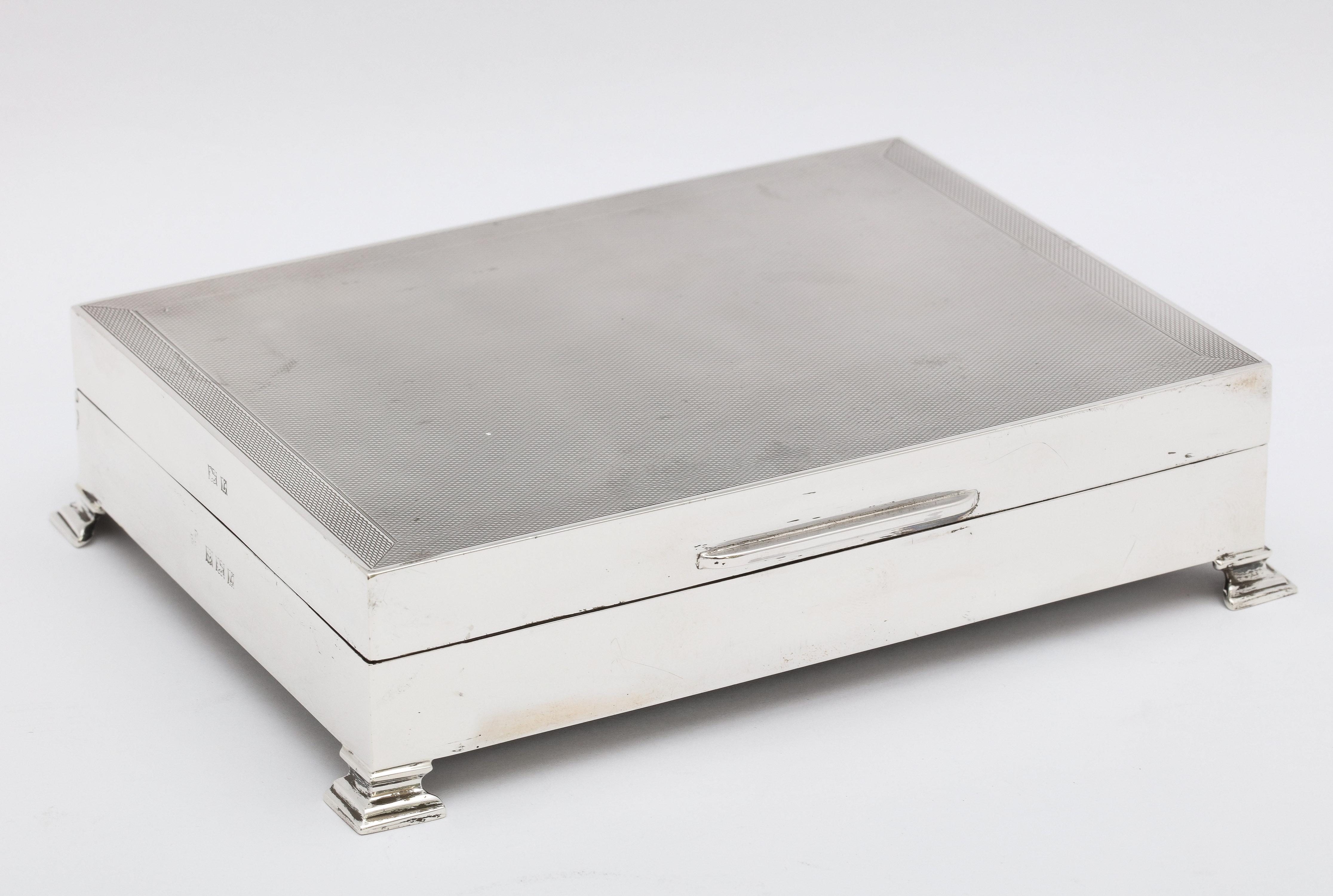 Art Deco style, engine-turned, footed table box with hinged lid, Birmingham, England, year-hallmarked for 1960, Jay Richard Attenborough and Co., Ltd. - makers. Measures 6 1/2 inches wide (from outer edge of foot to outer edge of opposite foot) x 5