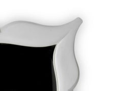 Art Deco style stucco mirror in “mustache” shape. 1990s.