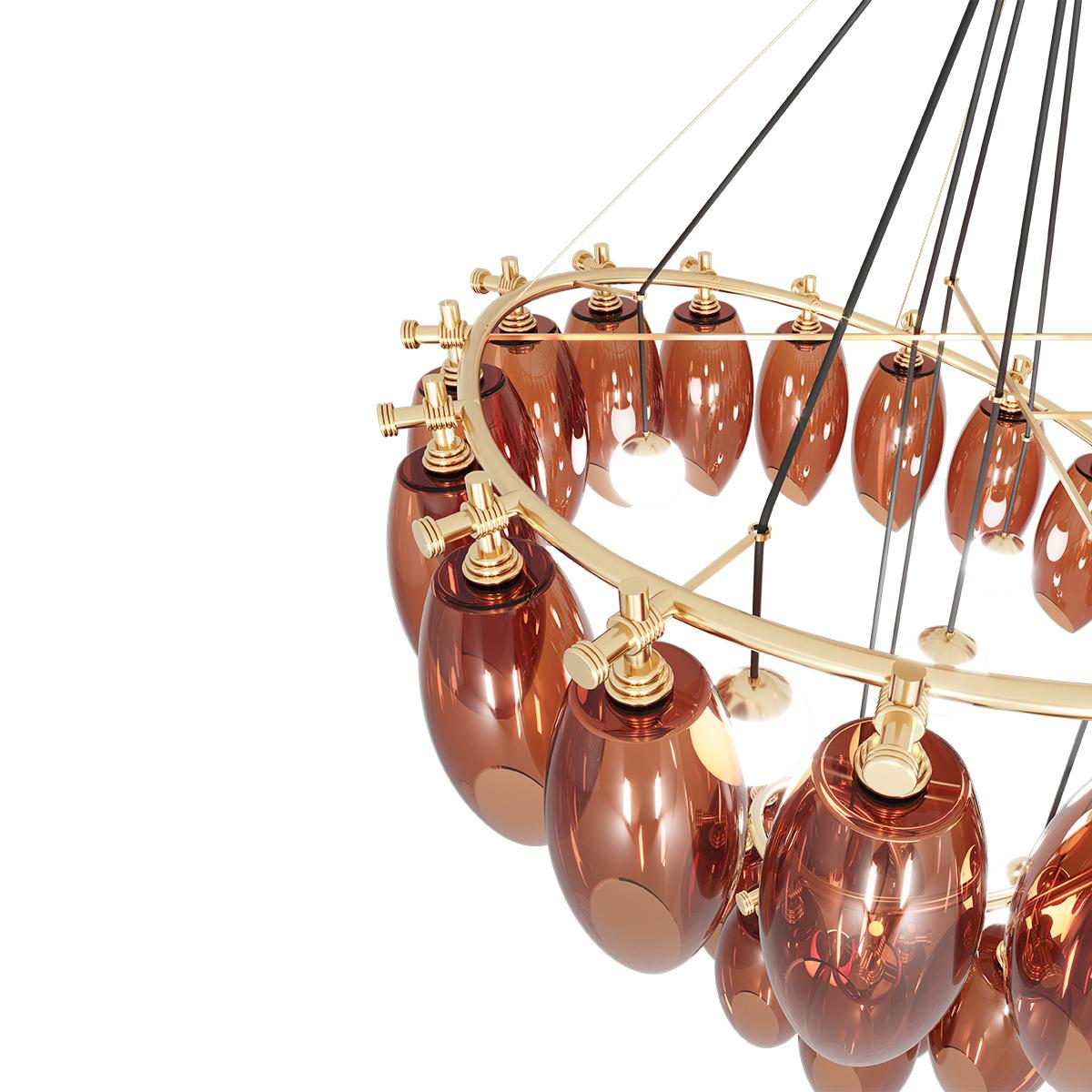 Cocoon Suspension Lamp is inspired by the shapes of Art Deco jewels. It was designed to bring elegance and character to any living area. A luxury chandelier for a high-end interior design project.

Materials: Structure in Polished Brass; Amber