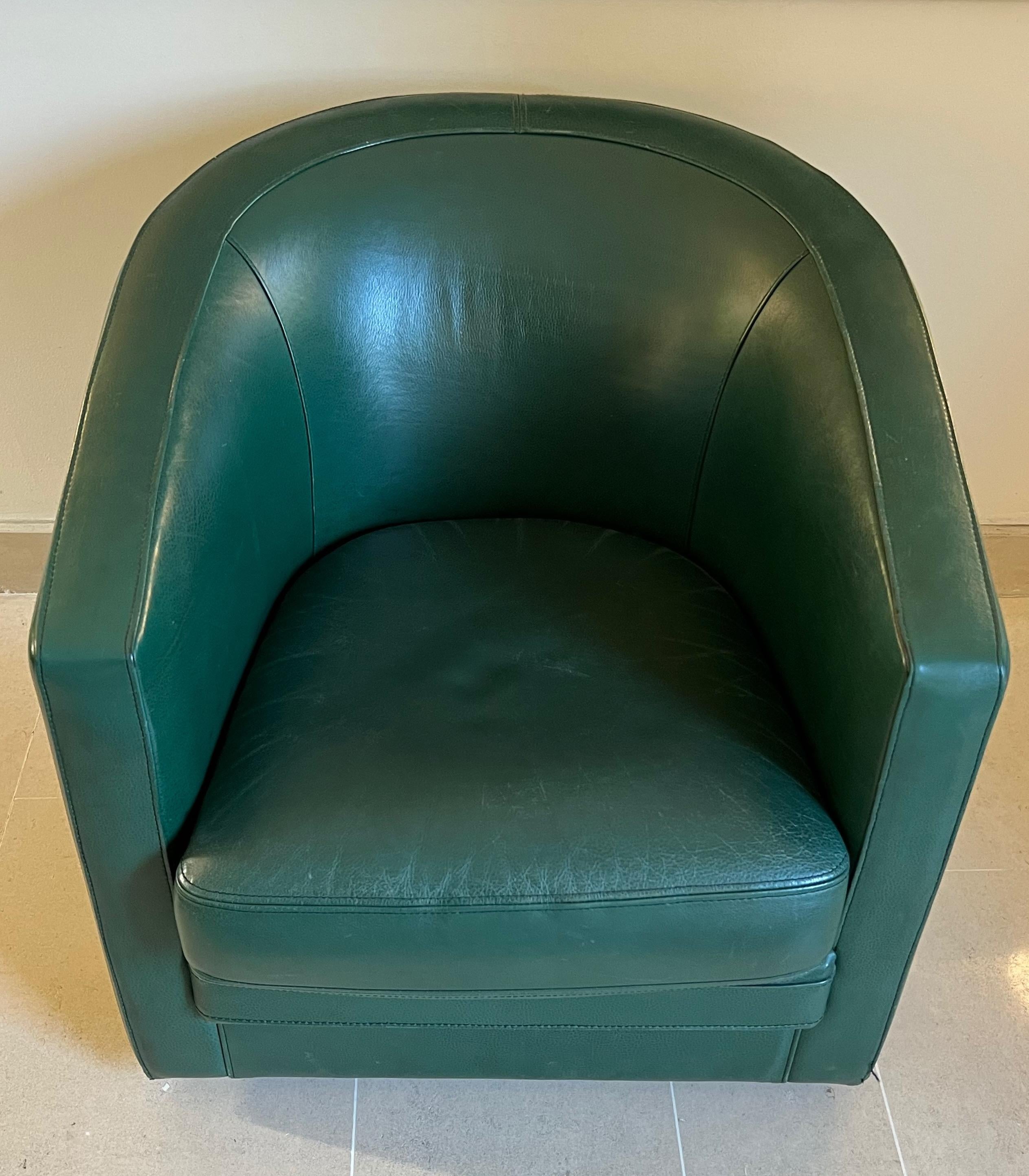This swivel club armchair is made of dark green leather. This is a french work in the Art Deco style. Circa 1980. This armchair can be sold separately but is part of a set including a 3 seats Sofa and a 2 seat sofa of the same design that you can