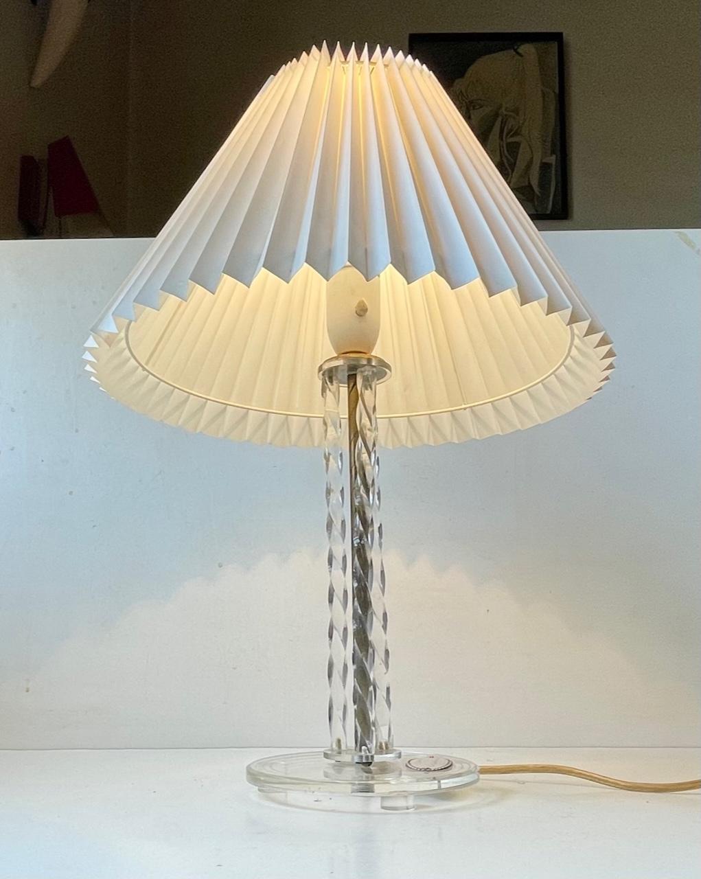 A stylish table light that is composed of 3 clear twisted lucite columns around a brass center-stem/pole that also has a twisted pattern incised. It has a Copenhagen Sterling silver platter referring to a Garden Association in Sundbyvester