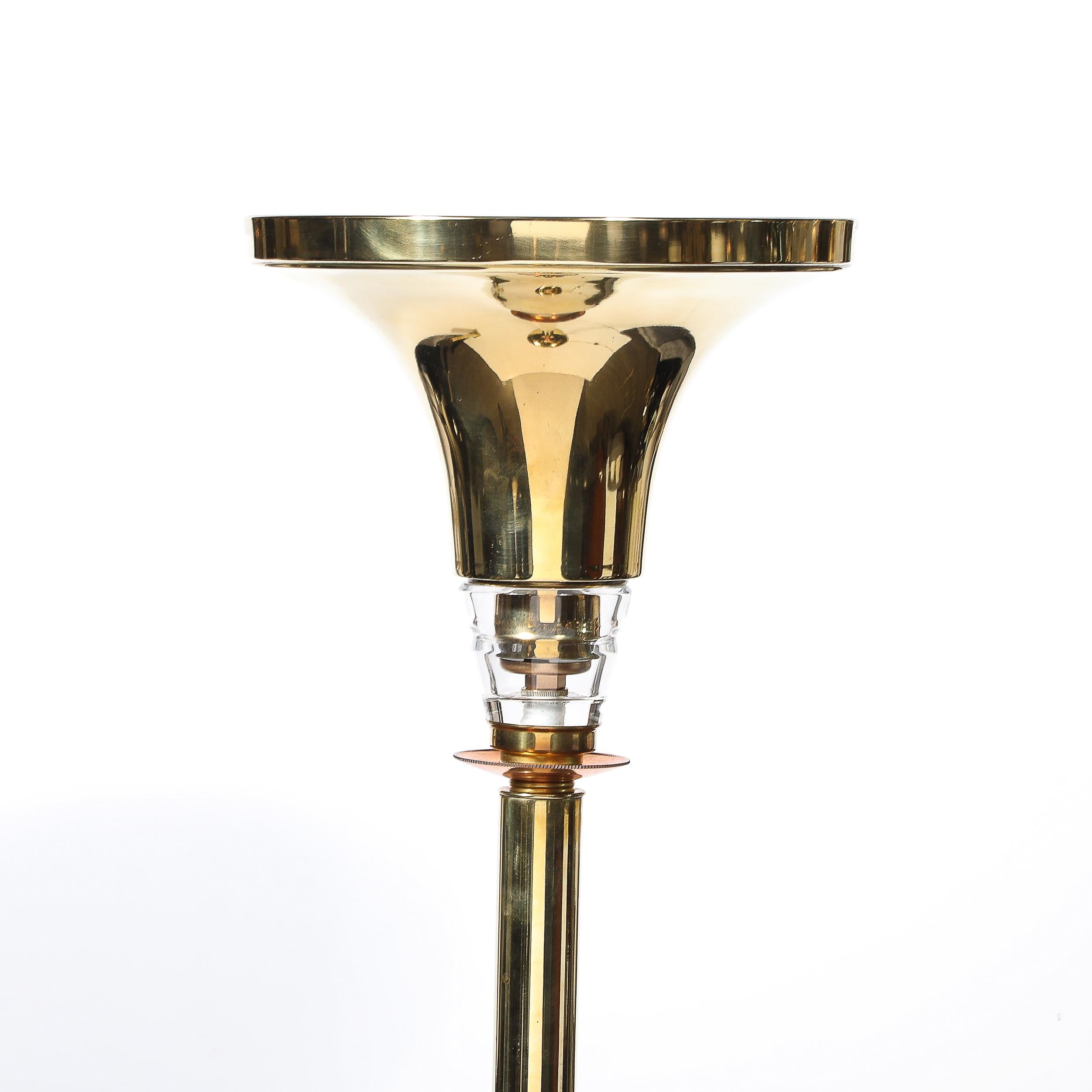 This lamp stands as a stunning example of Art Deco revival design, capturing the essence of the original movement while incorporating modern materials. The polished brass body exudes a warm, reflective glow, instantly drawing attention and adding a