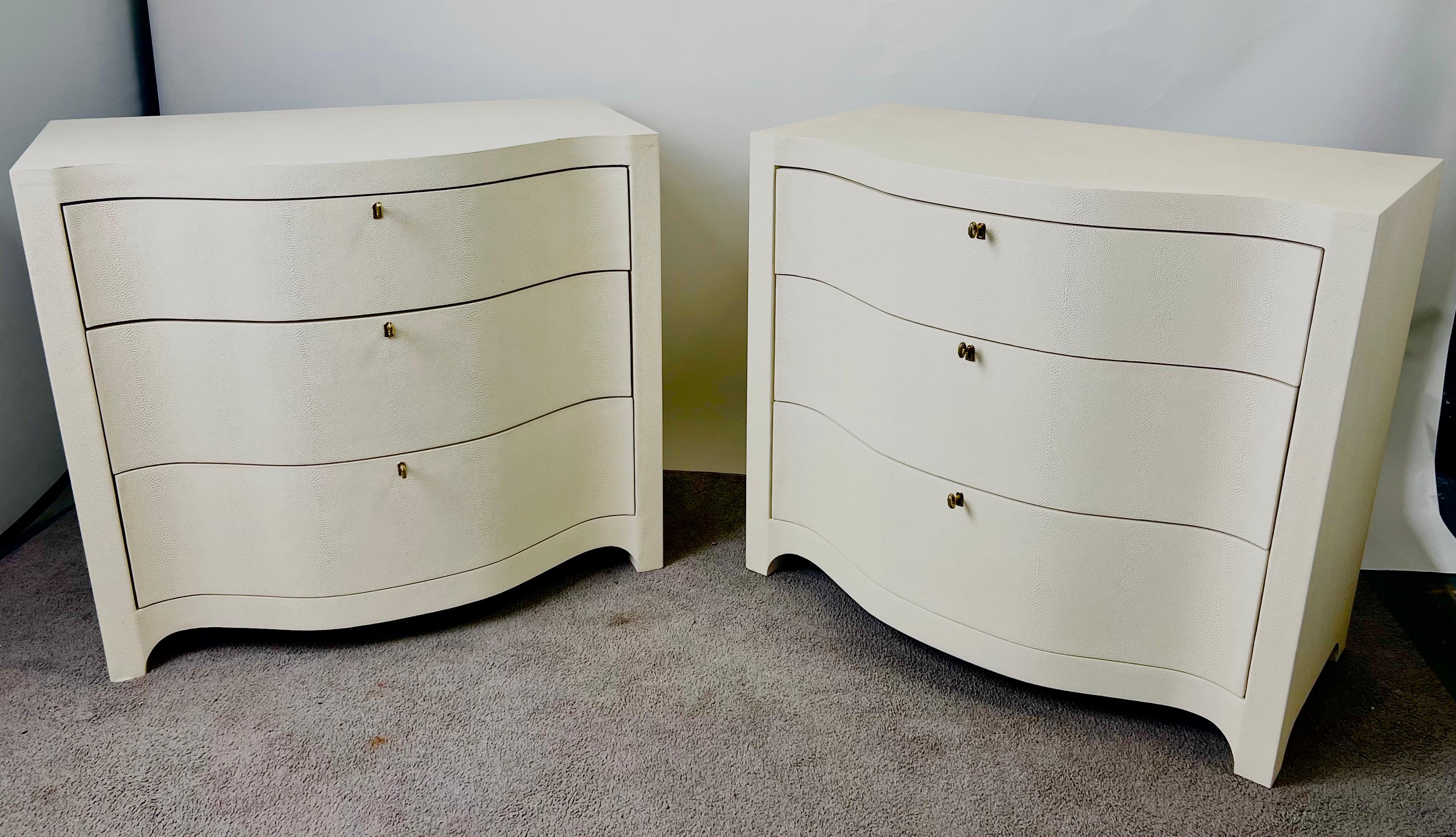 
A Pair of Art DecoStyle Transitional Ivory or off-white Serpentine Faux Shagreen Embossed Three Drawers Nightstands or dressers : 

A refined balance of vintage glamour and modern restraint, this exquisite pair of nightstands draws inspiration from