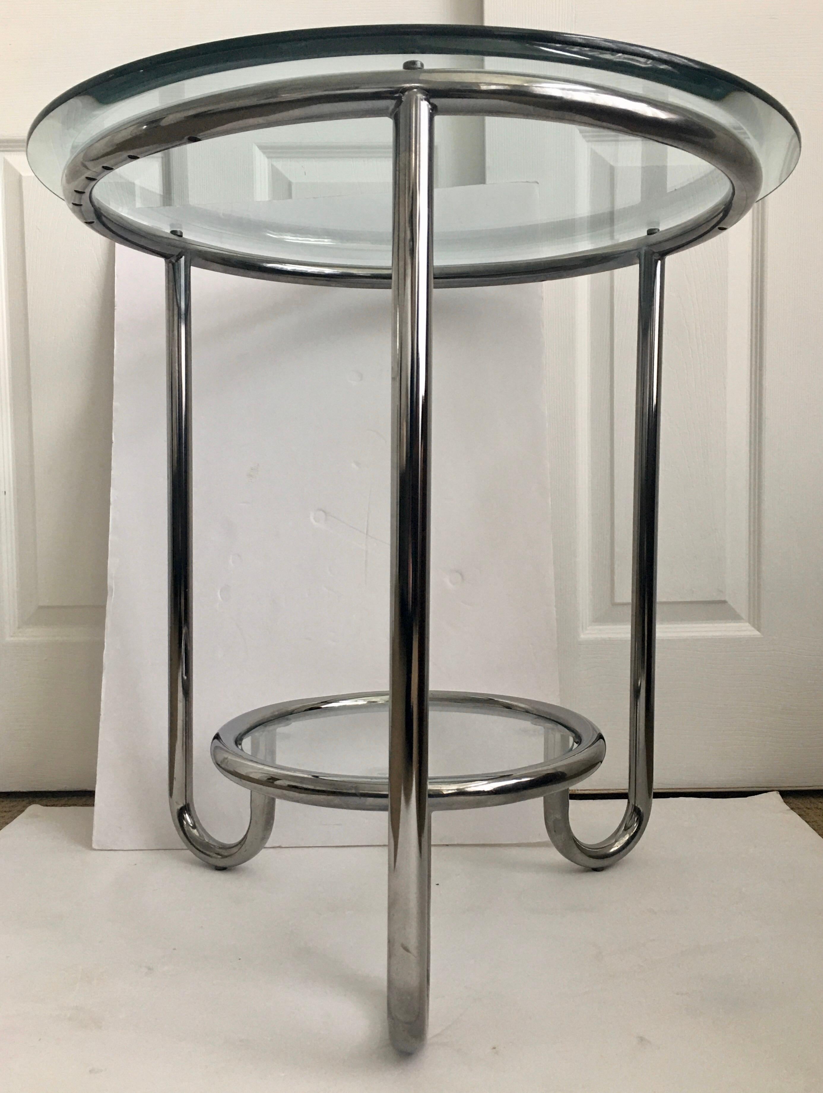 Art Deco style J-Leg tubular chrome and glass occasional end or side table in the style of Warren Mcarthur.  The modern sculptural two tier frame features curved U-shaped hair pin legs and holds two removable clear glass tops. Large round glass top