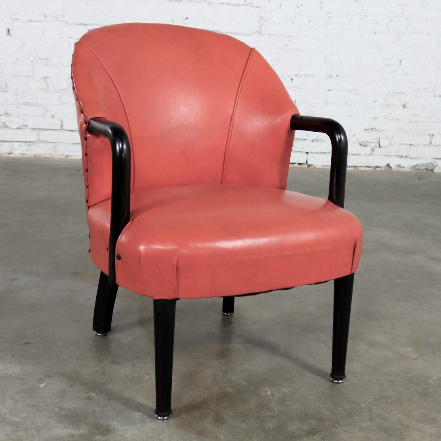 Handsome Art Deco style lounge armchair in red orange vinyl upholstery and black bentwood arms and legs. It is in wonderful vintage condition. And, retains its original faux leather upholstery and ebonized finish. Both show signs of age and use.