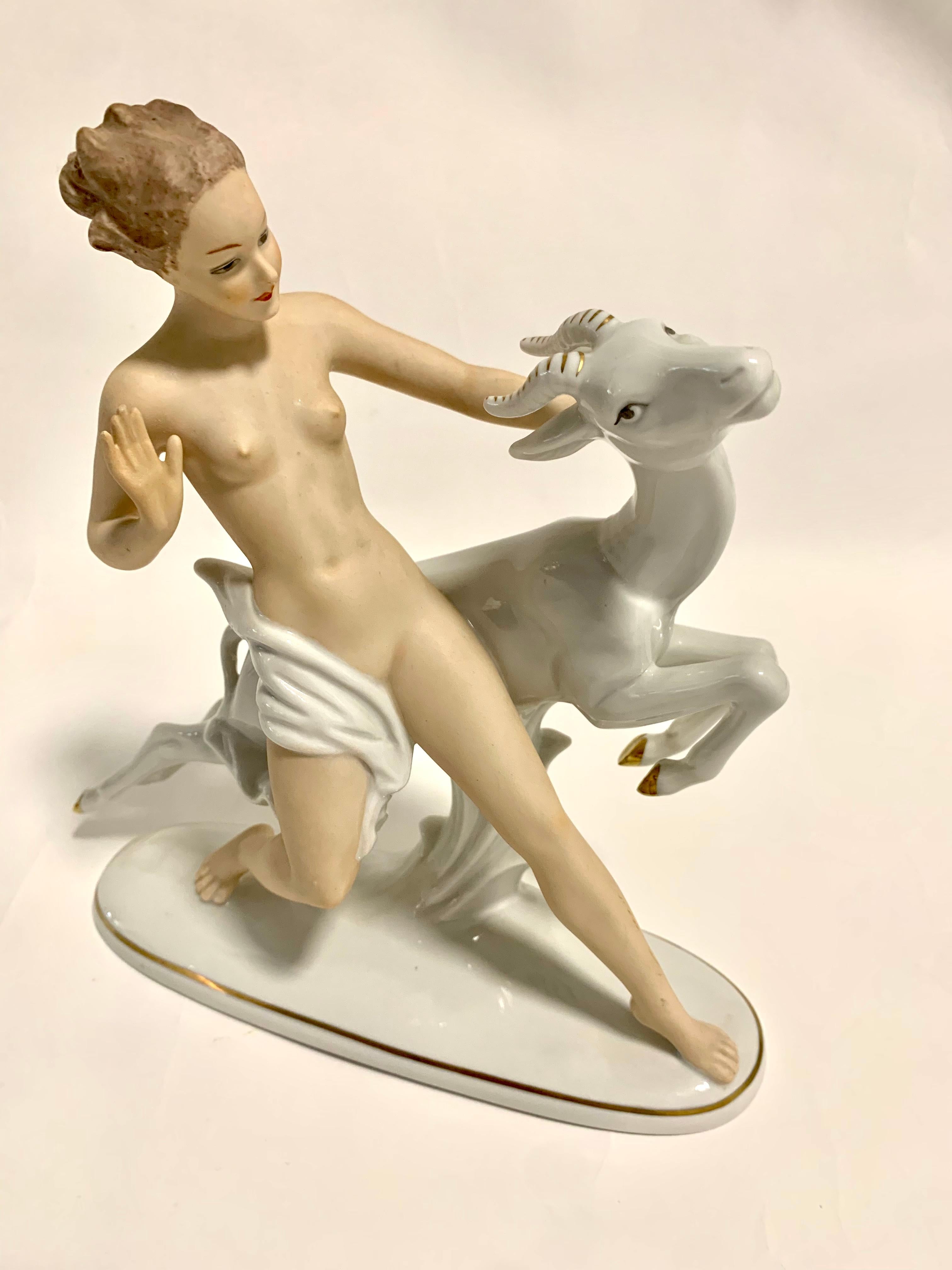 From every angle, this porcelain figurine is stunning. It is a Wallendorf, (Schaubach Kunst) that dates to about 1964. She is an Art Deco style draped nude standing next to a gazelle type animal. The girl is nude bisque and the rest of the figurine