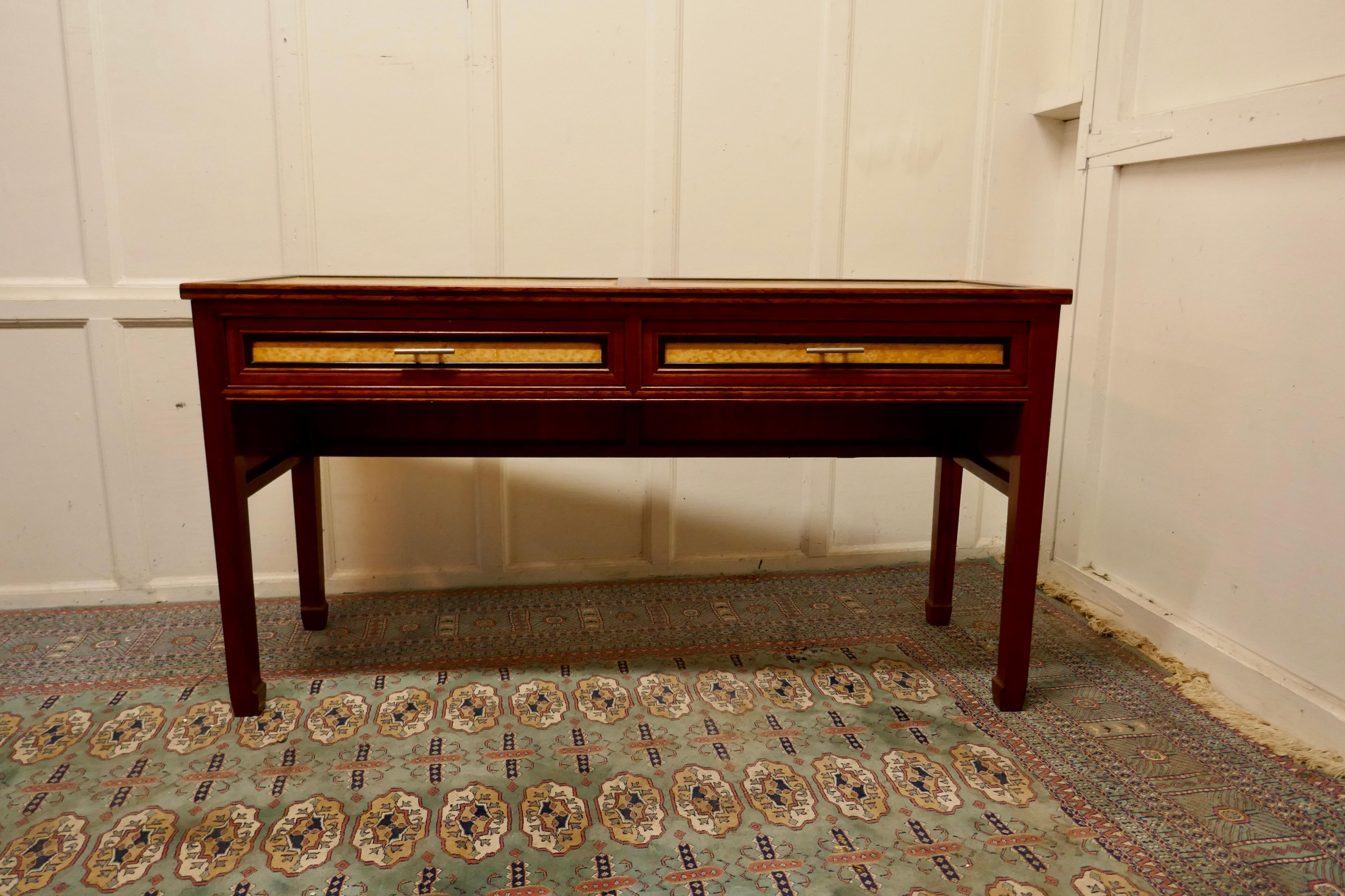 Art Deco style walnut and maple reception desk

This very stylish Art Deco style desk is made with beautifully figured Bird’s Eye Maple inset panels, there are 2 fall front slide covers over the kneehole
The Desk has the original slide drawers