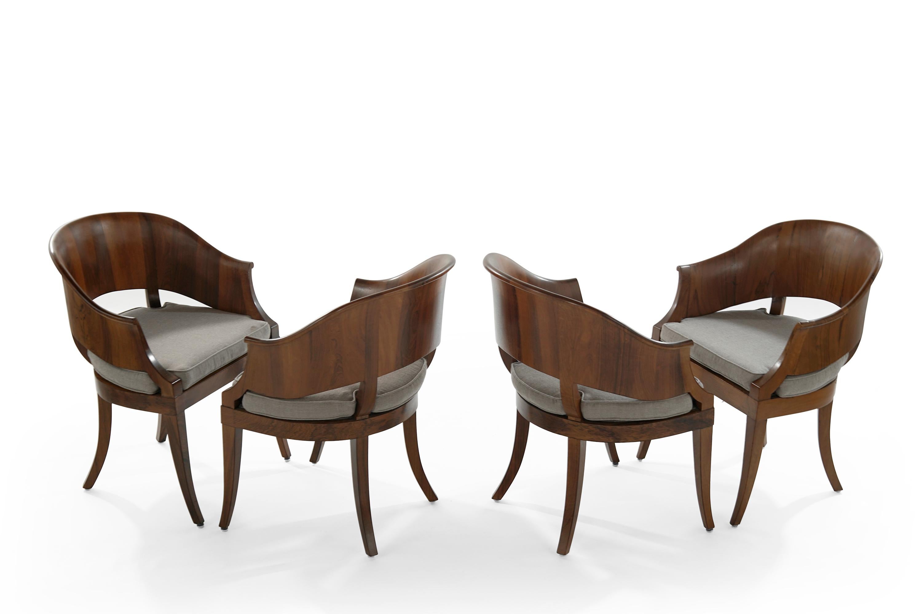 Set of four art deco style hand sculptured walnut armchairs. Walnut fully restored, newly linen upholstered cushions.