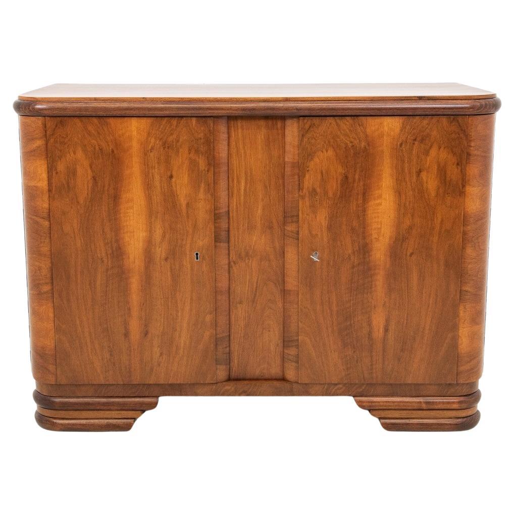 Art Deco style walnut chest of drawers, Poland, 1950s. For Sale