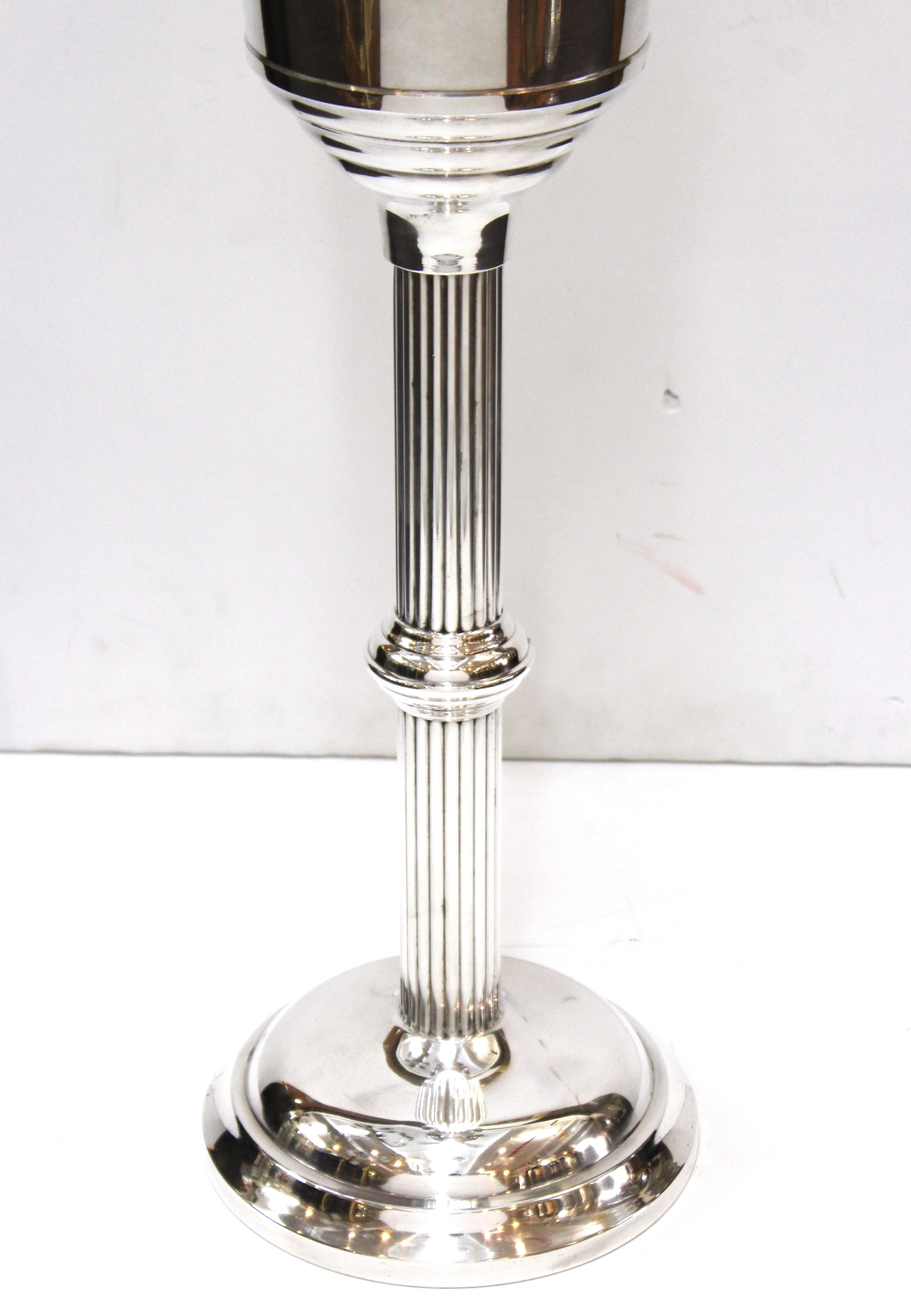 Art Deco style chrome champagne ice bucket with matching stand, made by WearBright. The top edge of the bucket is stepped with a band. Made during the 1950s in the United States. The piece is in great vintage condition with age-appropriate wear.
