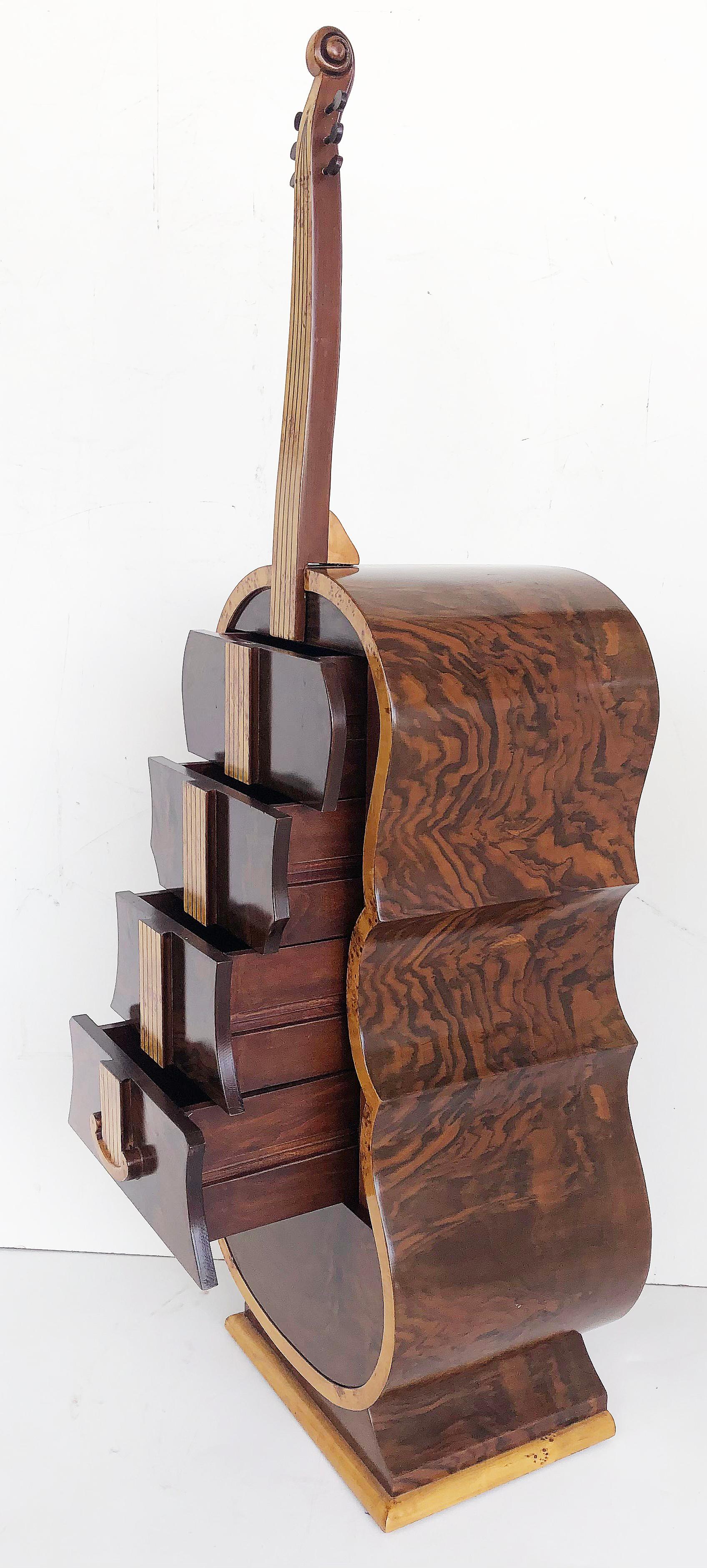Art Deco-style whimsical burl wood cello shaped cabinet with secret compartment.

Offered for sale is an art deco-style whimsical exotic burl wood chest of drawers created in the form of a standing cello. The cabinet has matched-grain veneers,
