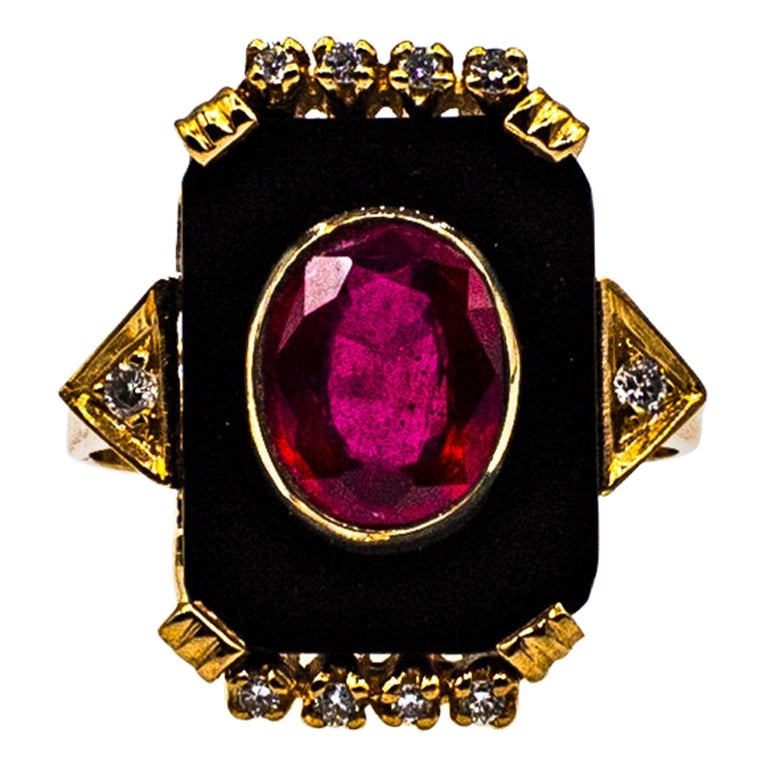 This Ring is made of 14K Yellow Gold.
This Ring has 0.15 Carats of White Brilliant Cut Diamonds.
This Ring has a 2.40 Carats Natural Oval Cut Treated Ruby.
This Ring has also Onyx.

This Ring is available also with a central Turquoise, a central