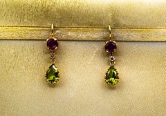 Pendientes de oro amarillo estilo art déco con diamante blanco, peridoto y rubí