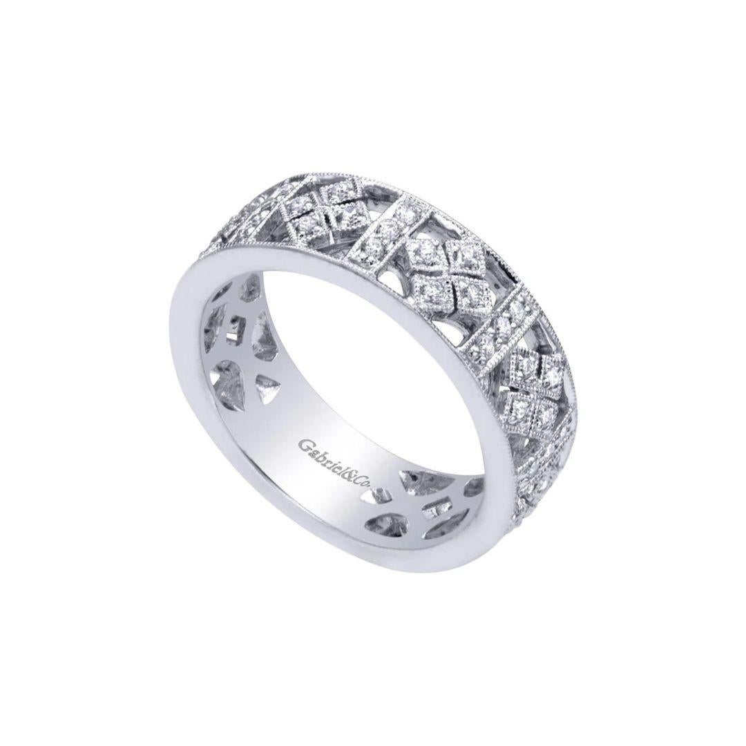 Art Deco style diamond pave band with a fusion of geometric and retro motifs, created by New York bridal designer Gabriel Co. Band contains 0.30 ctw of fine white round diamonds, H color, SI clarity. Band is suitable as an unique wedding band, a