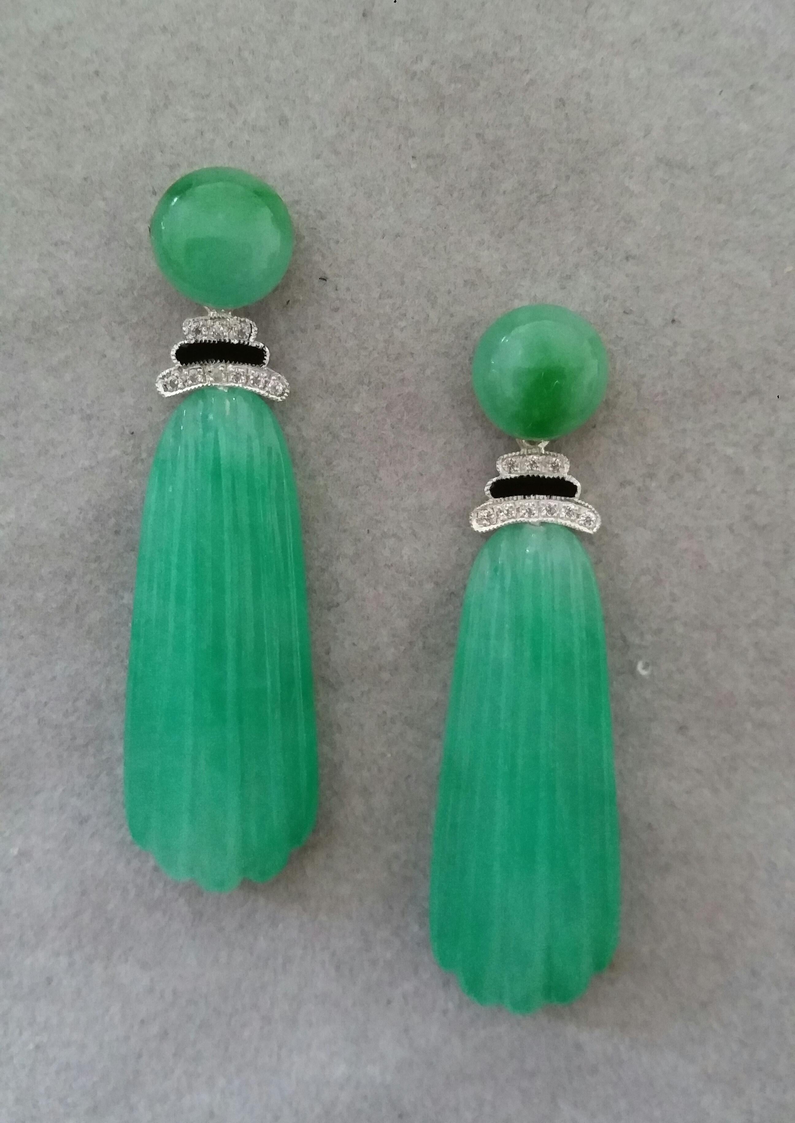 In these classic Art Deco Style earrings we have the tops with 2 round Jade buttons of 10 mm in diameter,the middle parts  are composed of 2 elements  in White Gold , Diamonds and Black Enamel,while in the bottom parts  we have 2  Burma Jade