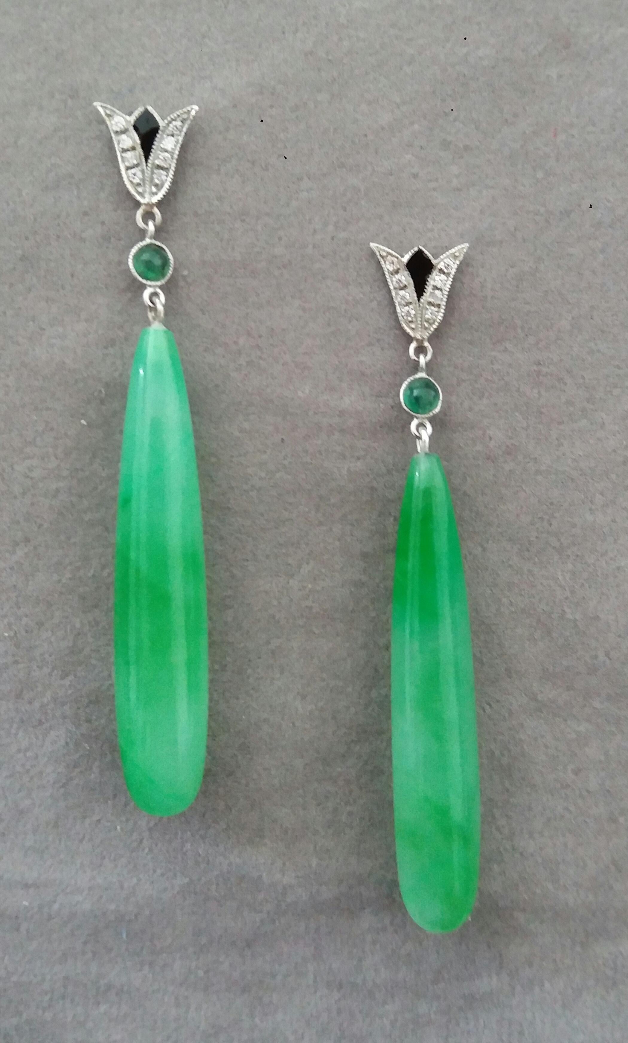 In these classic Art Deco Style earrings the tops are 2 parts  in 14 kt.white gold, 16 round full cut diamonds,small round emerald cabs and black enamel ,in the lower parts we have 2 Burma Jade long plain round  drops measuring 7 x 40 mm
In 1978 our