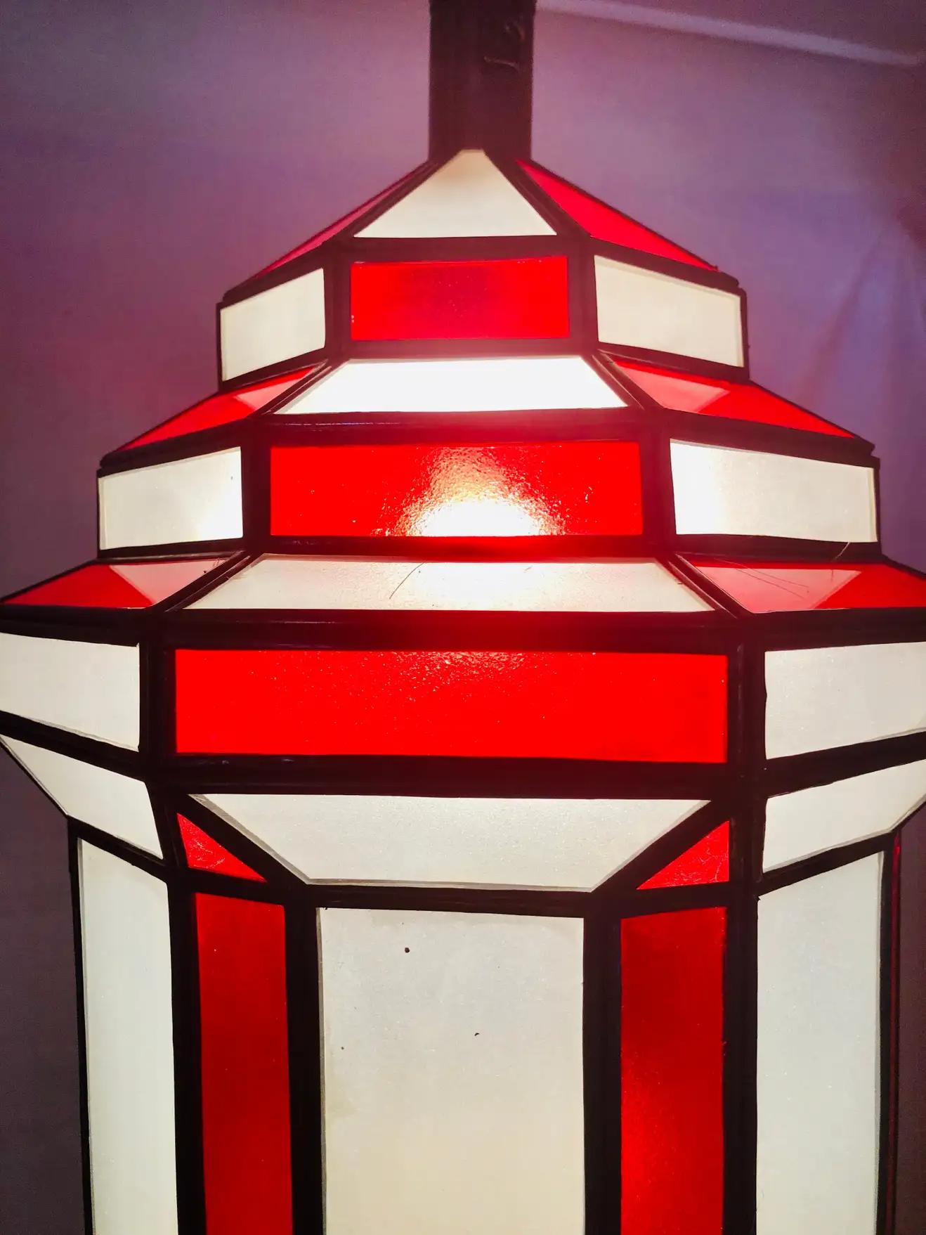 Art Deco style white milk and red glass chandelier, pendant or lantern
A gorgeous handcrafted red and while pendant, having individual panes.The Art Deco hanging lantern or ceiling fixture features sandblasted frosted milky white and red glass and