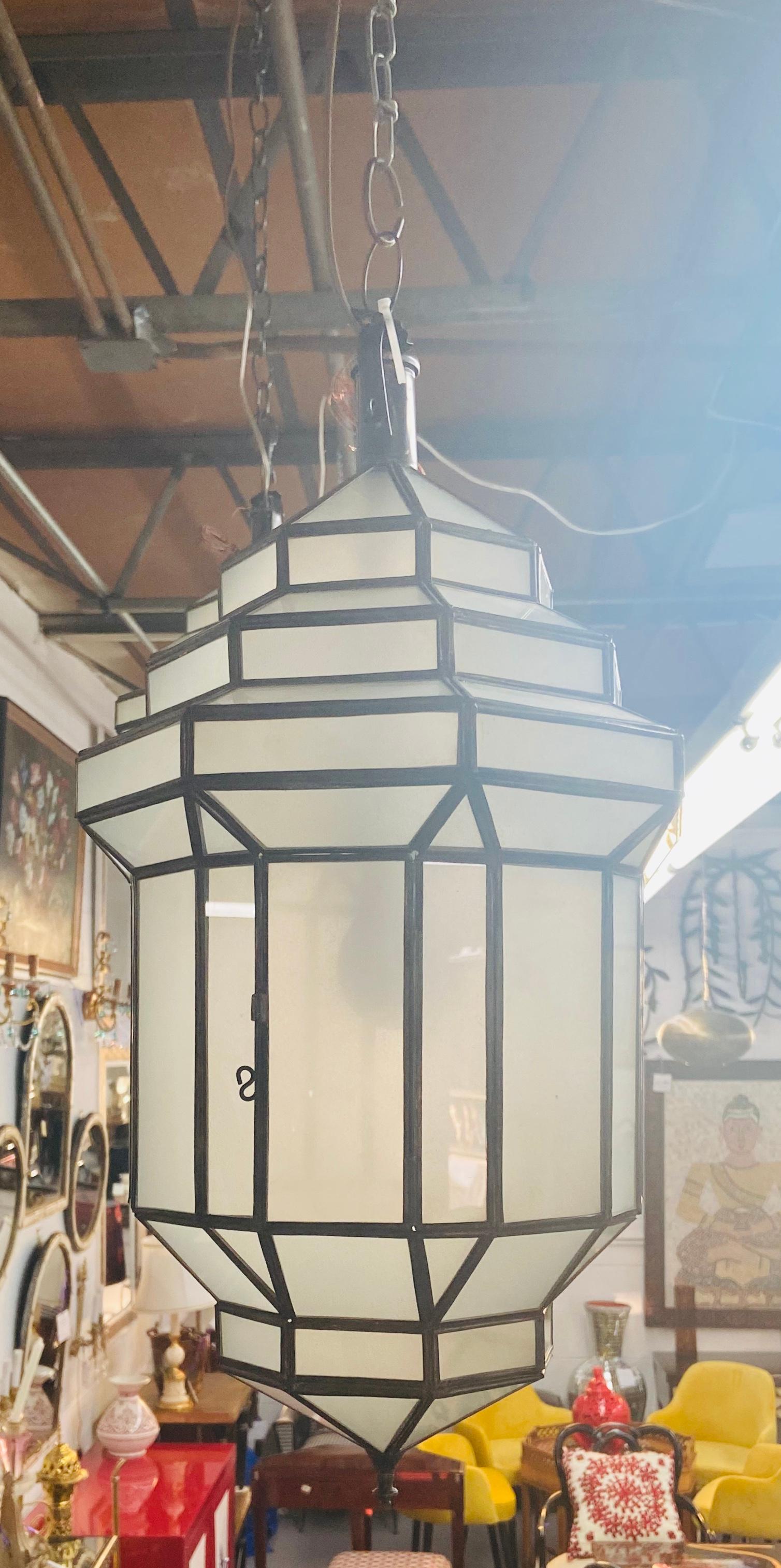 Art Deco style white milk glass handmade chandelier, pendant, lantern, a pair
A gorgeous handcrafted with individual panels, this pair of Art Deco hanging lanterns or ceiling fixtures features sandblasted frosted milky glass and patinated metal
