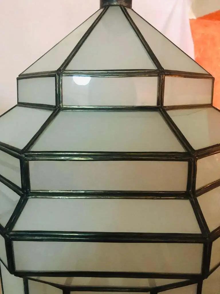 A Large Art Deco white milk glass handmade chandelier, pendant lantern, Gorgeously handcrafted, having individual panes. The hanging lantern or ceiling fixture features sandblasted frosted milky glass and patinated metal frames. The octagonal shaped