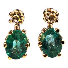 Boucles d
oreilles à levier de style Art déco en or jaune avec diamants blancs taille rose et émeraudes