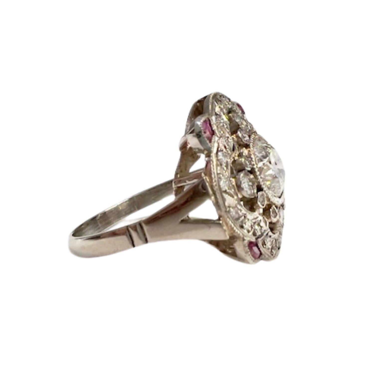 Step into the glamour of the Art Deco era with this exquisite platinum ring adorned with a central diamond and rubies. The central diamond weighs 1.00 carat with PI1 clarity and H color, complemented by brilliant-cut diamonds totaling 0.50 carats.