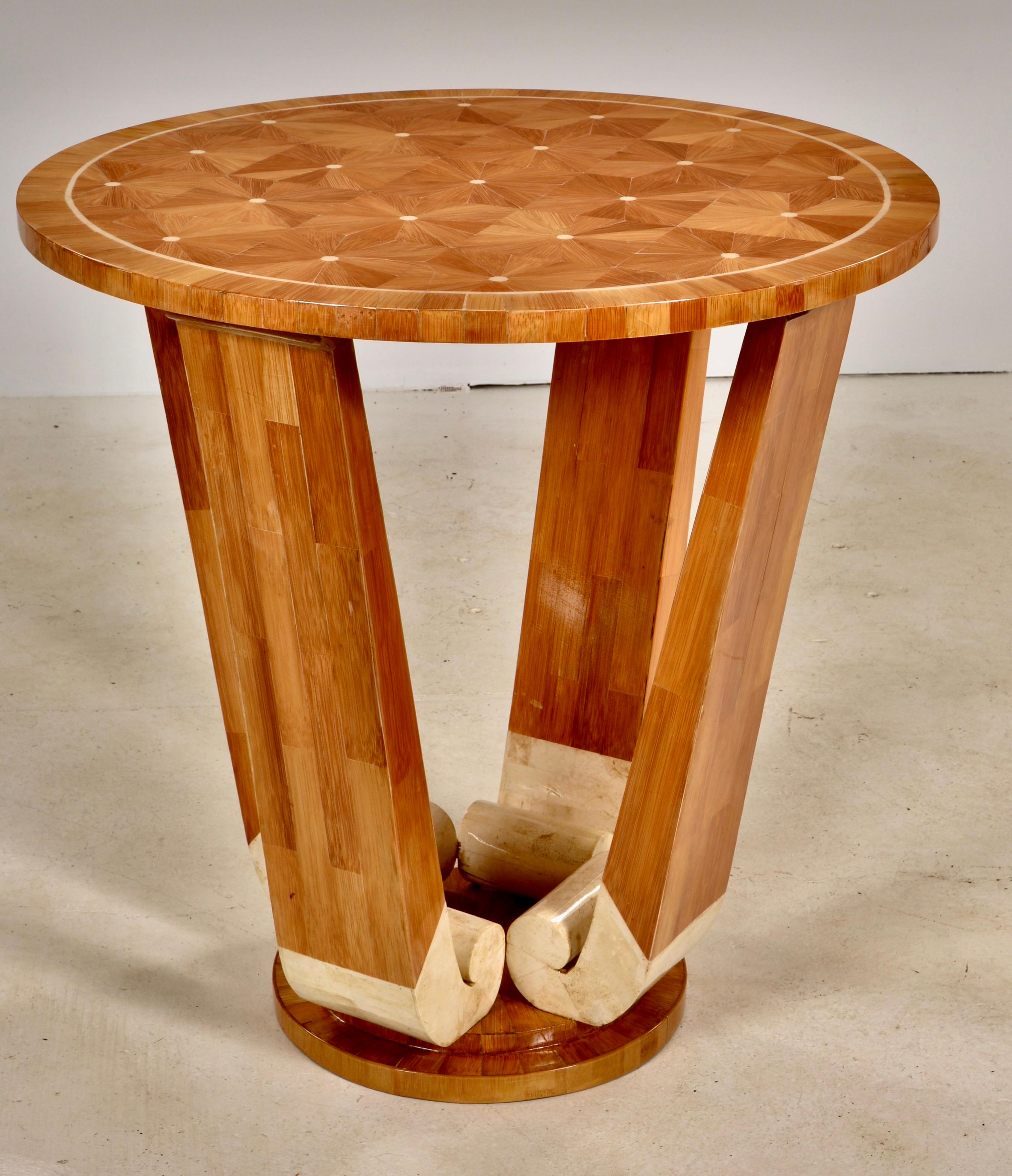 A lovely Art Deco style table in a classic tulip form features hand inlaid details with a parquetry design inlaid with bone, and bone clad decorative base. Beautiful coloration, newly refinished with a high gloss lacquer. In very fine condition.