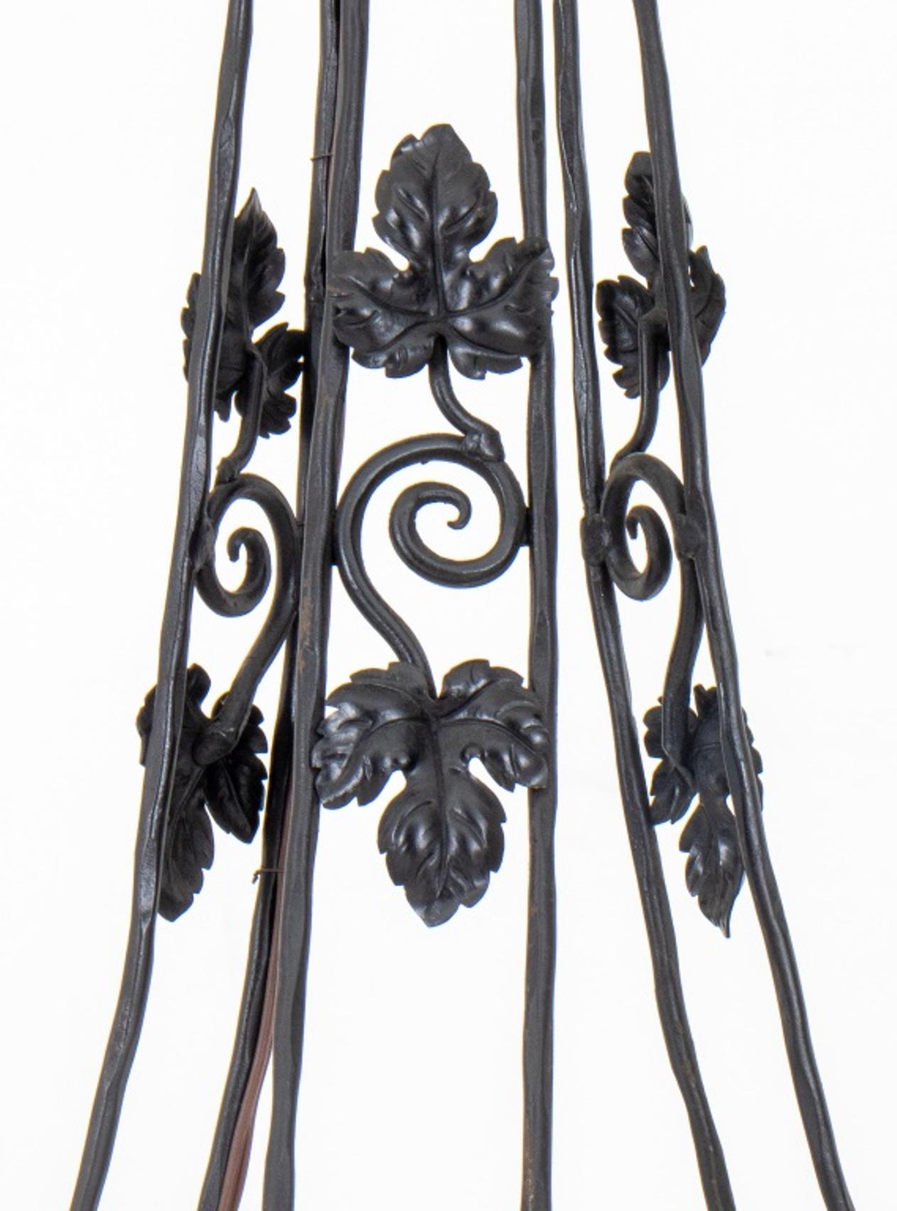 Art Deco manner wrought iron hall lantern in the manner of Muller Freres, with central matte colored glass bell within a cage form chandelier mount with wrought iron ivy or chestnut leaf motifs.

Dimensions: 38
