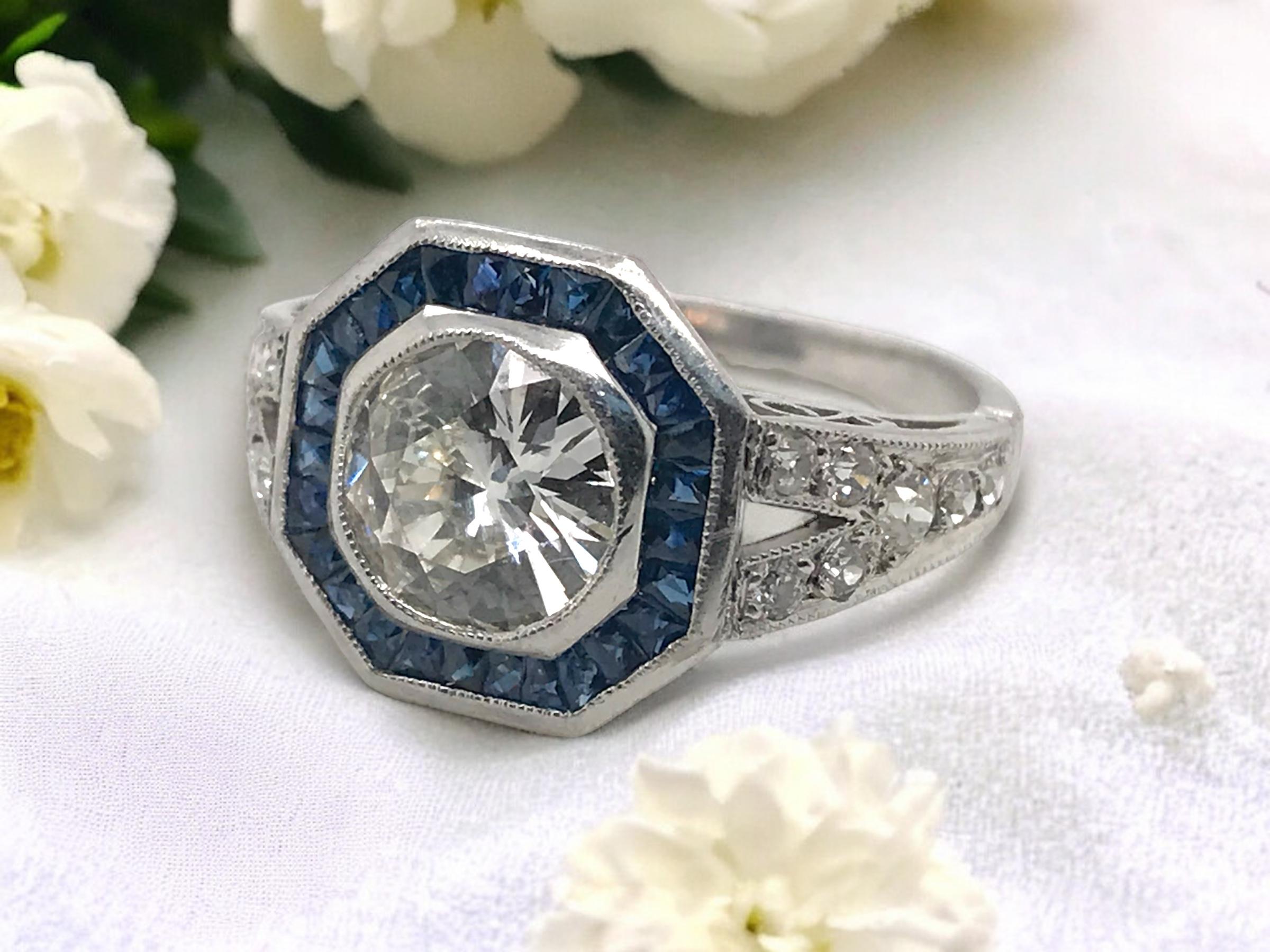 We always love diamonds accented by sapphires.
This beauty is absolutely stunning!!!

Ring Details
Material: Platinum
Weight: 3.9 Grams
Head Width: 12.3mm
Height: 5.6mm
Finger Size: 6 1/2
Sizable Upon Request

Accented by the following stones
1 -