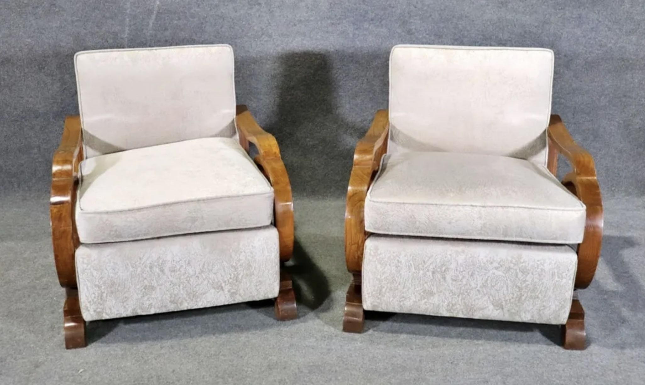 Pair of wide lounge chairs with dramatic wood arms. Art Deco style frame and soft cushioned seat and back.
Please confirm location NY or NJ