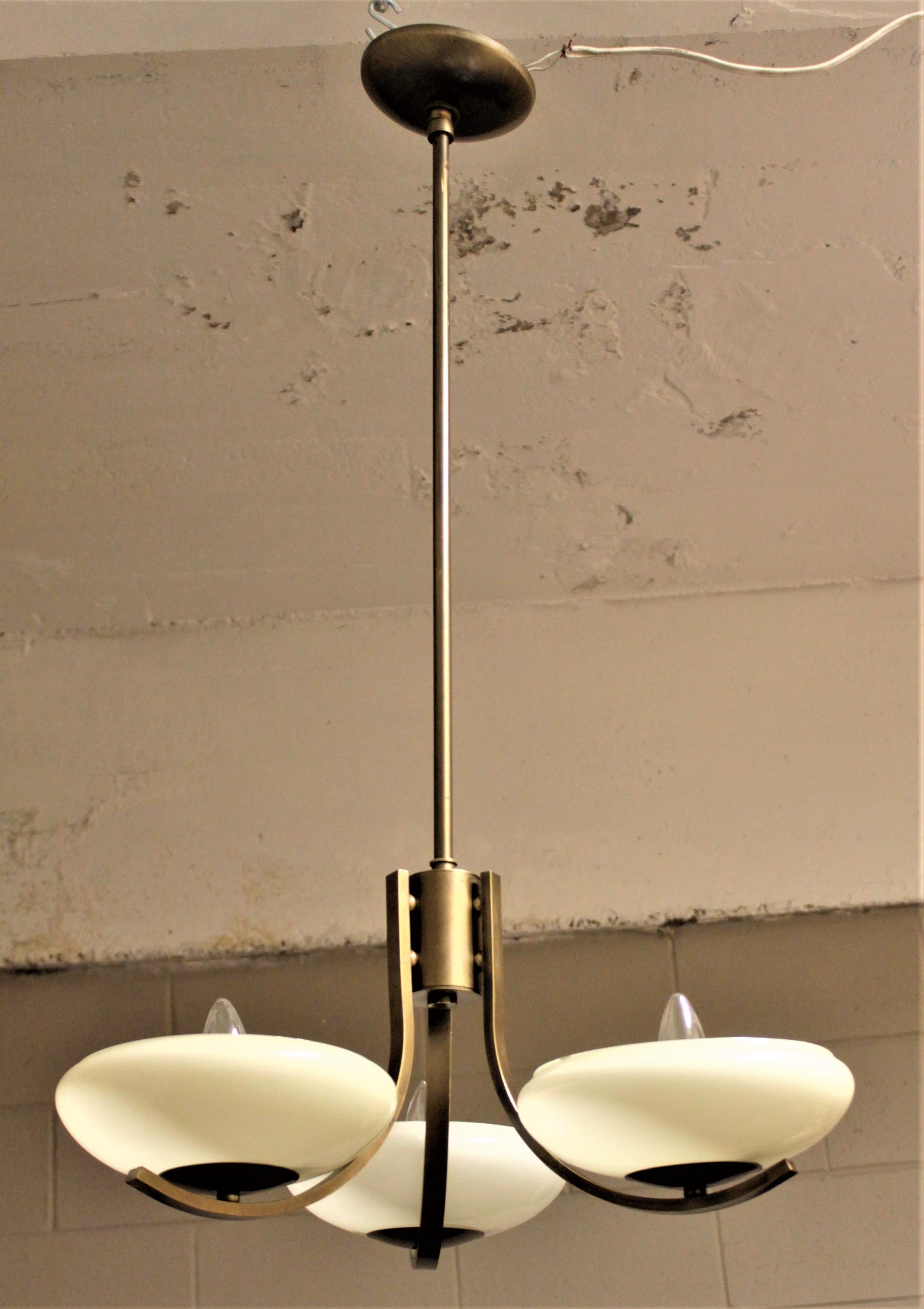 Art Deco Styled Brass Three Branch Chandelier with Off-White Glass Cupped Shades In Good Condition In Hamilton, Ontario