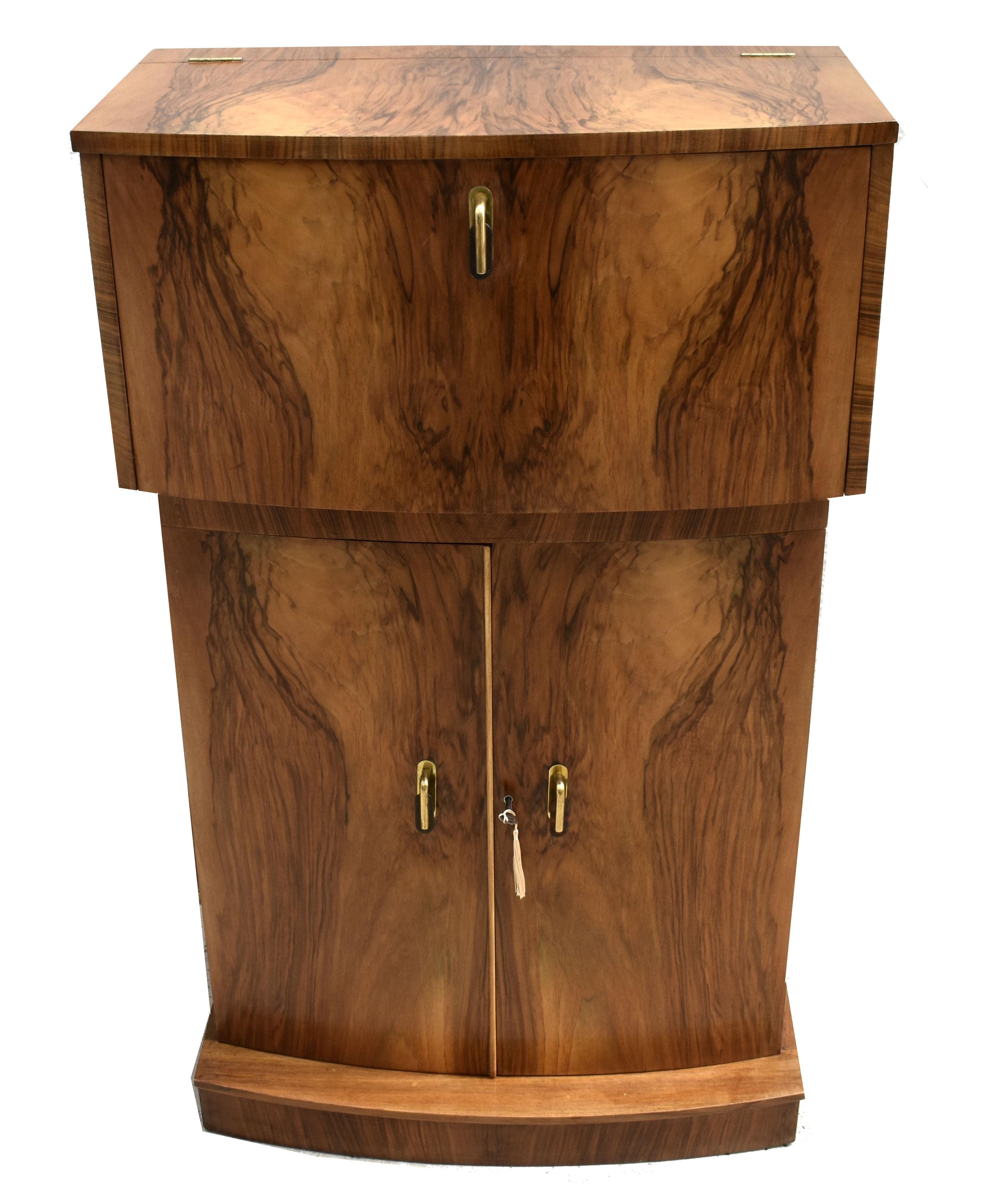 For your consideration is this fabulously stylish 1930's Art Deco cocktail cabinet. Wonderful and an unusual shape being of a stepped bow form. This cabinet dates from the 1930's and has all the bells and whistles you want from a cocktail cabinet.
