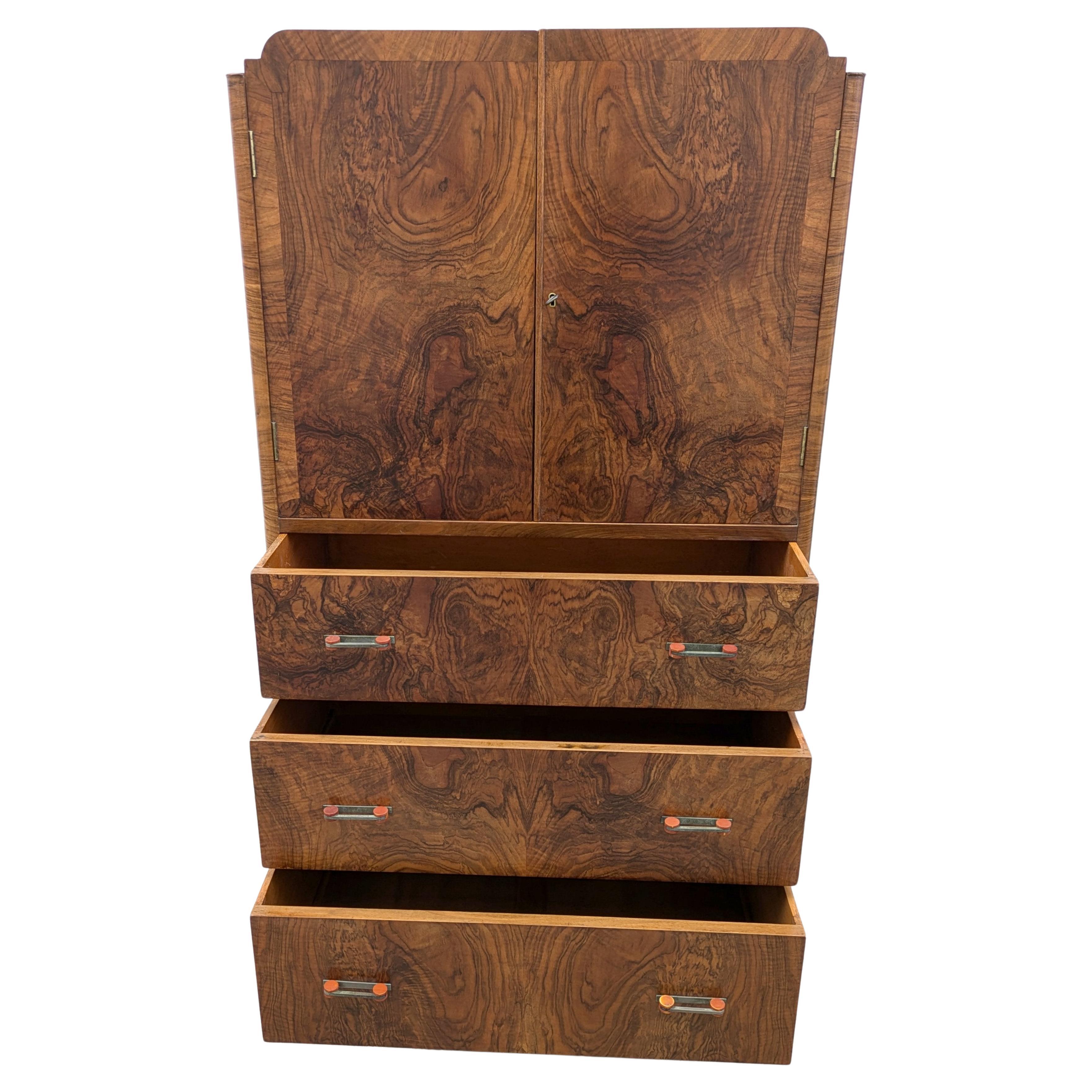 A real treasure from the 1930s is this Art Deco tallboy . On first viewing this piece one can't not be impressed by the obvious quality and size , made from solid mahogany for the carcass with a heavily figured walnut book paged veneers to the