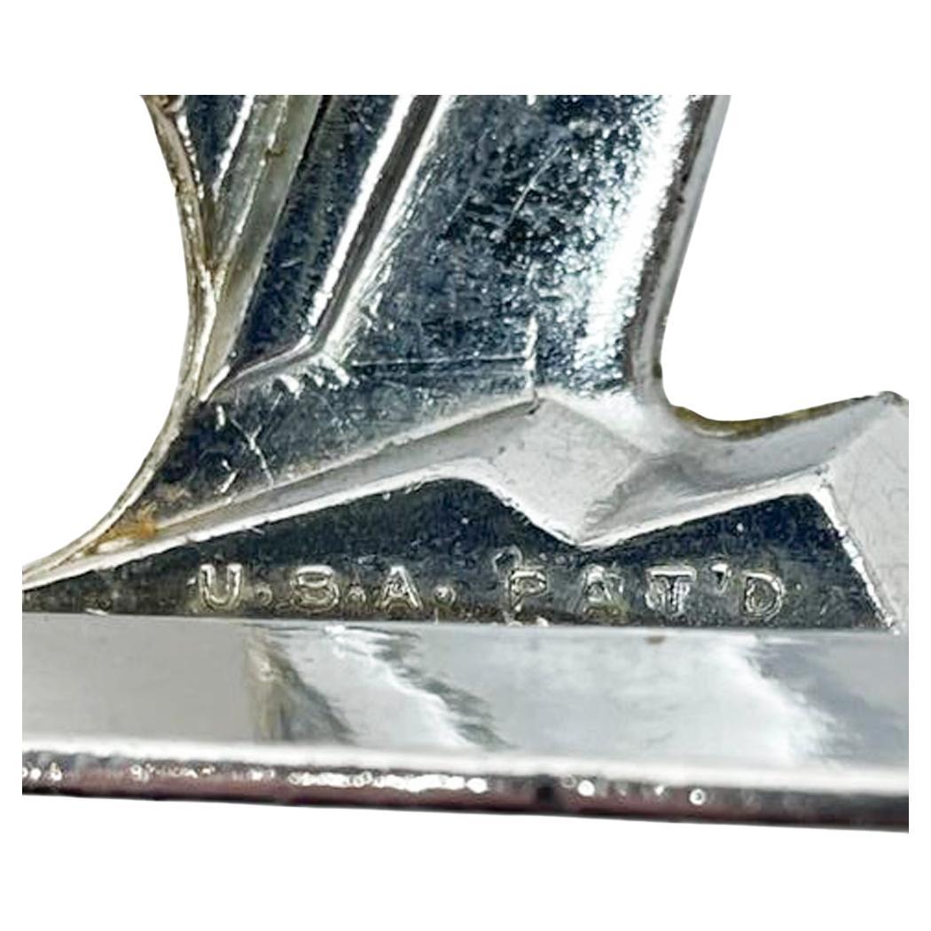 Art Deco stylized standing figure of a chrome plated parrot. Patented in 1929 its open mouth is a bottle opener while the corkscrew folds discretely into the back between the wings.