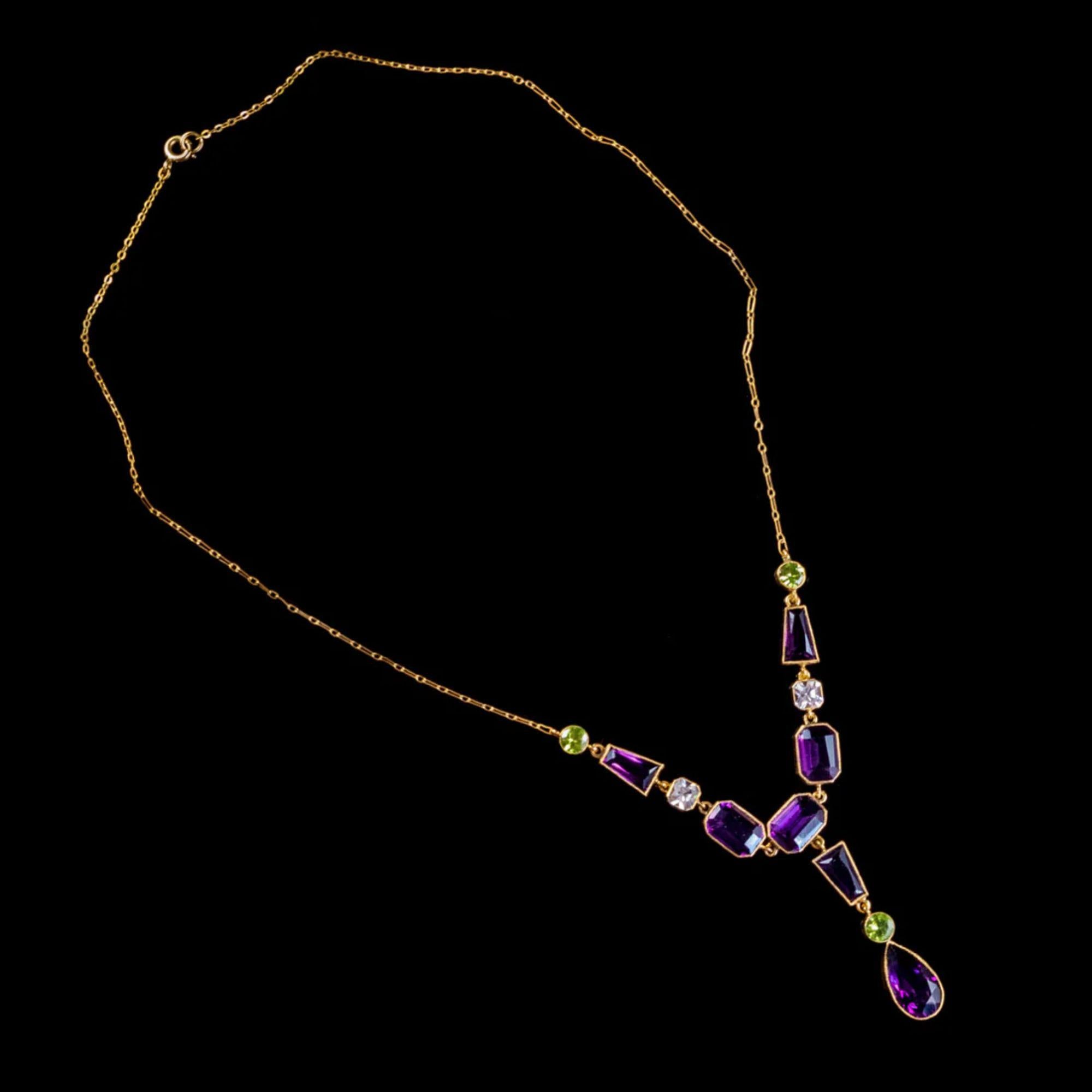 This magnificent Art Deco Suffragette lavaliere necklace has been commissioned in Silver and gilded with 18ct Yellow Gold. The lavaliere is set with an array of violet, green and white Pastes stones cut in various shapes and sizes which simulate