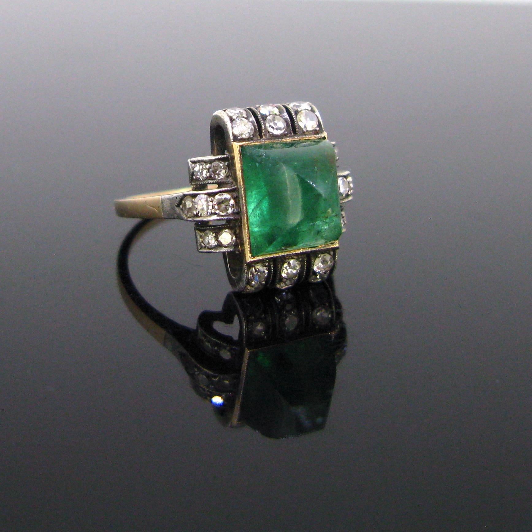 Weight:	3,5r

Circa:	Art Deco, circa 1920

Metal:	Gold and Silver

Stones:	1 Emerald
•	Cut:	Sugarloaf
•	Total carat weight:	3.15ct approximately
•	Dimensions:	8.4x7.5x6.8mm

Others:	26 single cut diamonds
•	Total carat weight: 	0.30ct