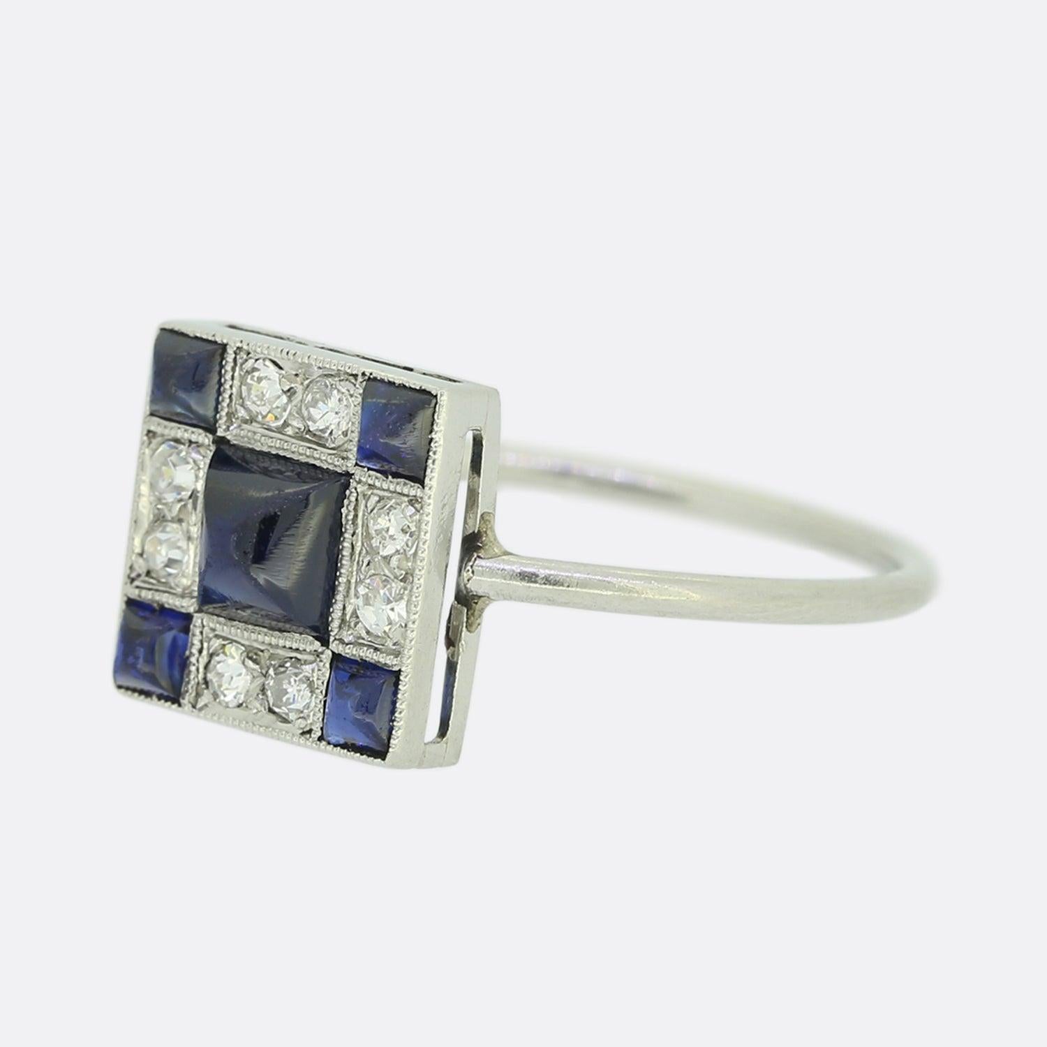 Here we have a wonderfully crafted sapphire and diamond ring perfectly exemplifying the Art Deco style. Rendered in 18ct white gold, the head of  this unique piece showcases five sugarloaf sapphires with the largest stone sitting at the centre. The